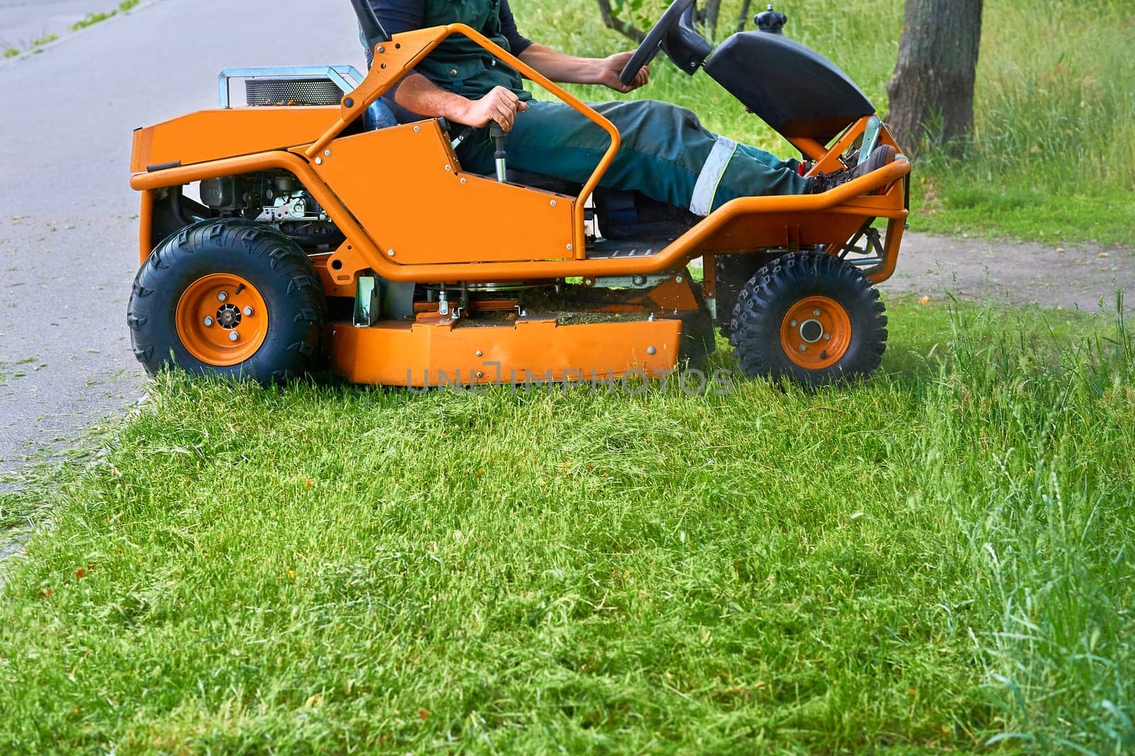 Professional grass cutting on lawns with a mini tractor lawn mower. by jovani68