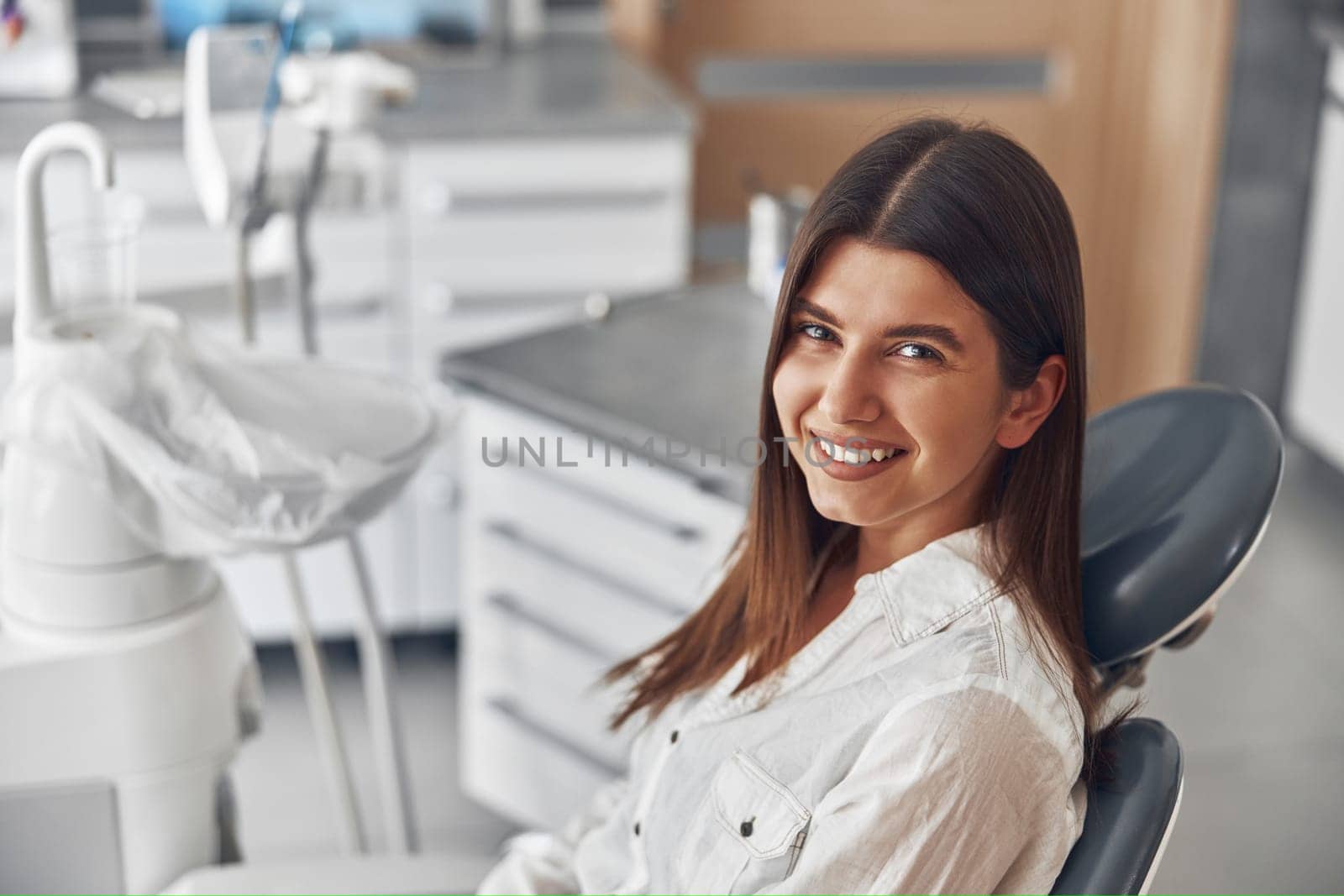 Happy caucasian woman at dentist cabinet by Yaroslav_astakhov