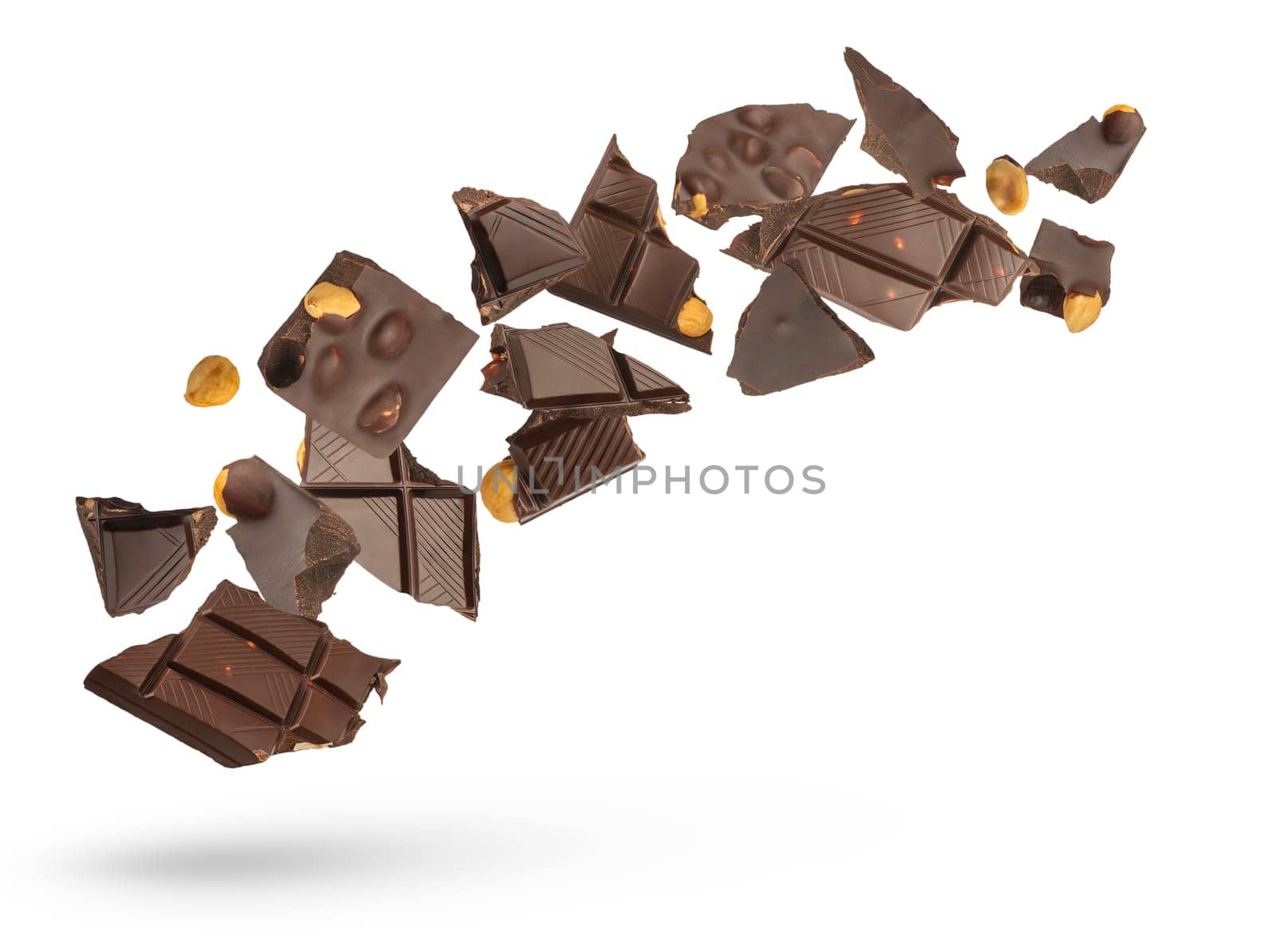 Dark chocolate with nuts on a white isolated background. Slices of fresh chocolate from different sides of different sizes scatter in different directions, close-up. by SERSOL