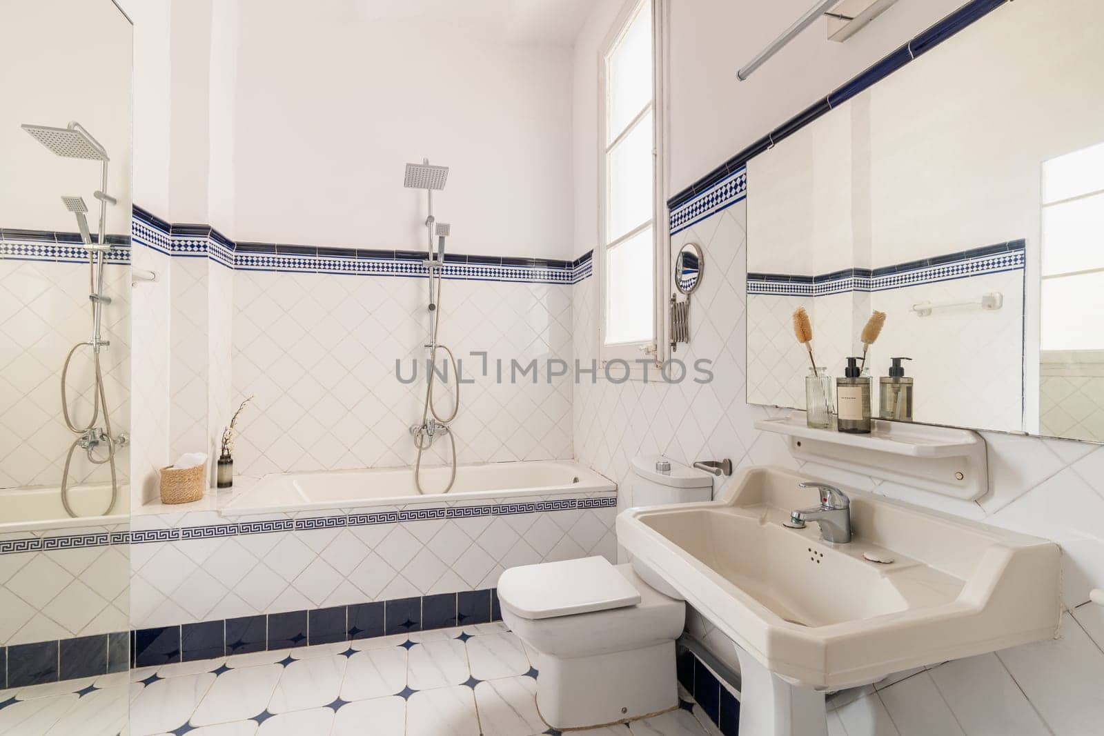 Modern interior design of a domestic bathroom with bathtub, shower, and sink by apavlin