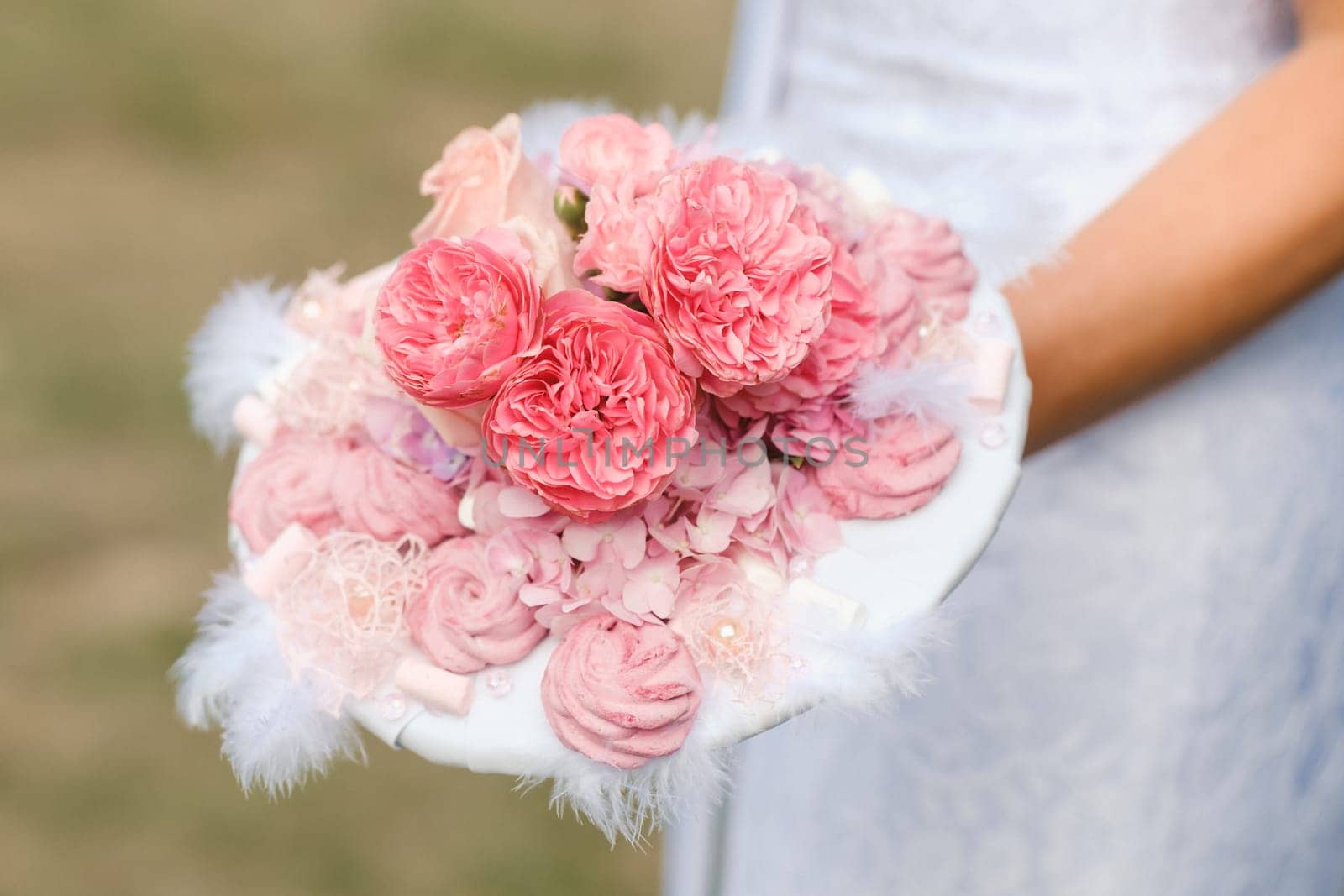 The bride holds her wedding bouquet in her hands.