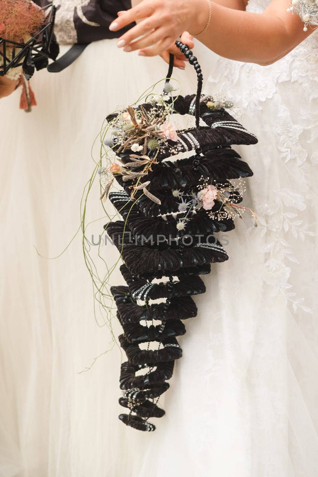 The bride holds her wedding bouquet in her hands.