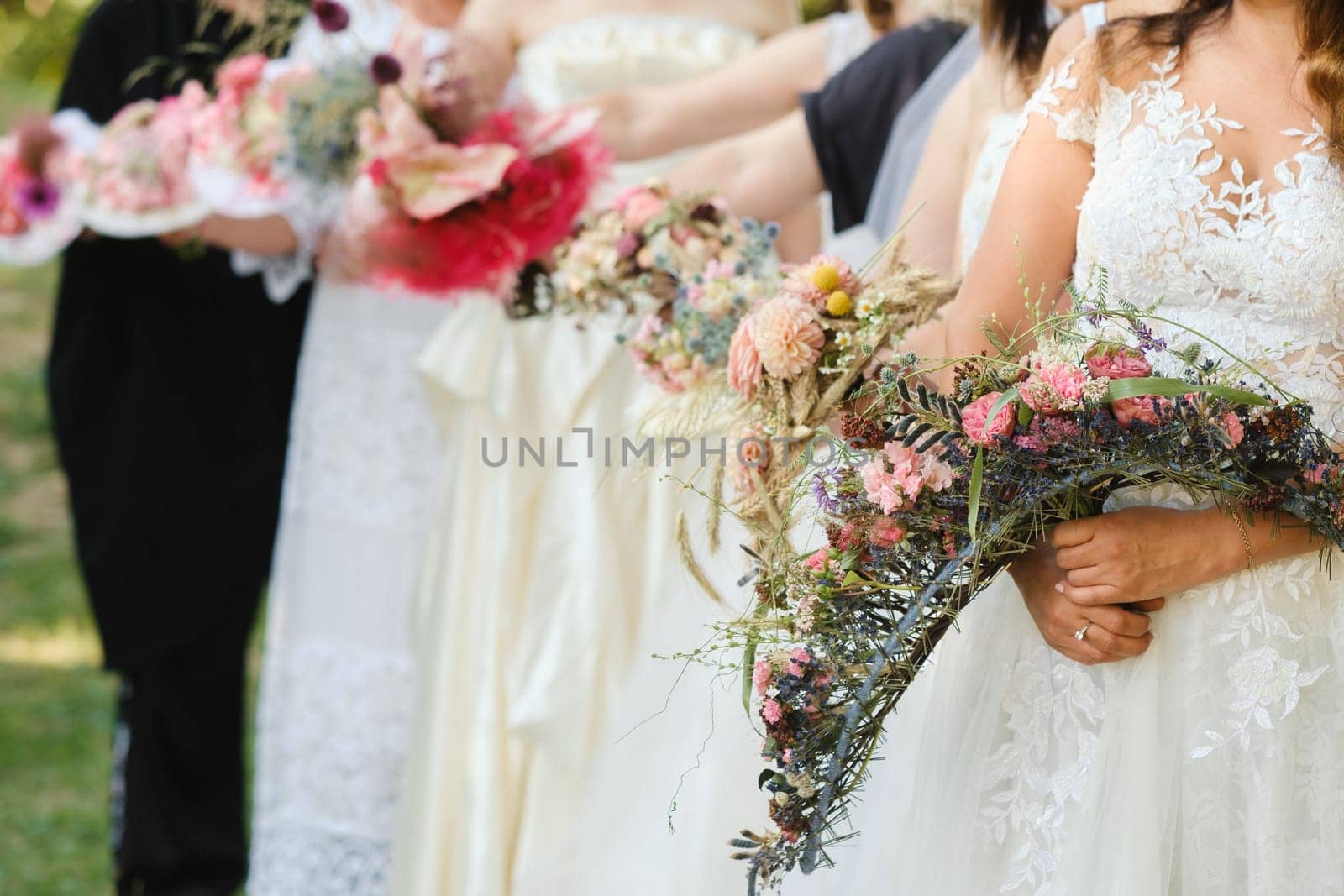 Many brides hold their wedding bouquet in their hands.