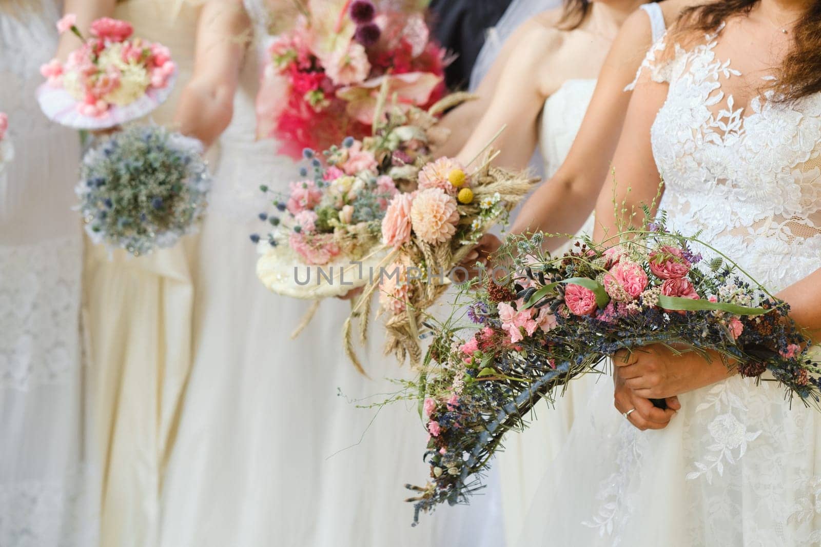 Many brides hold their wedding bouquet in their hands.