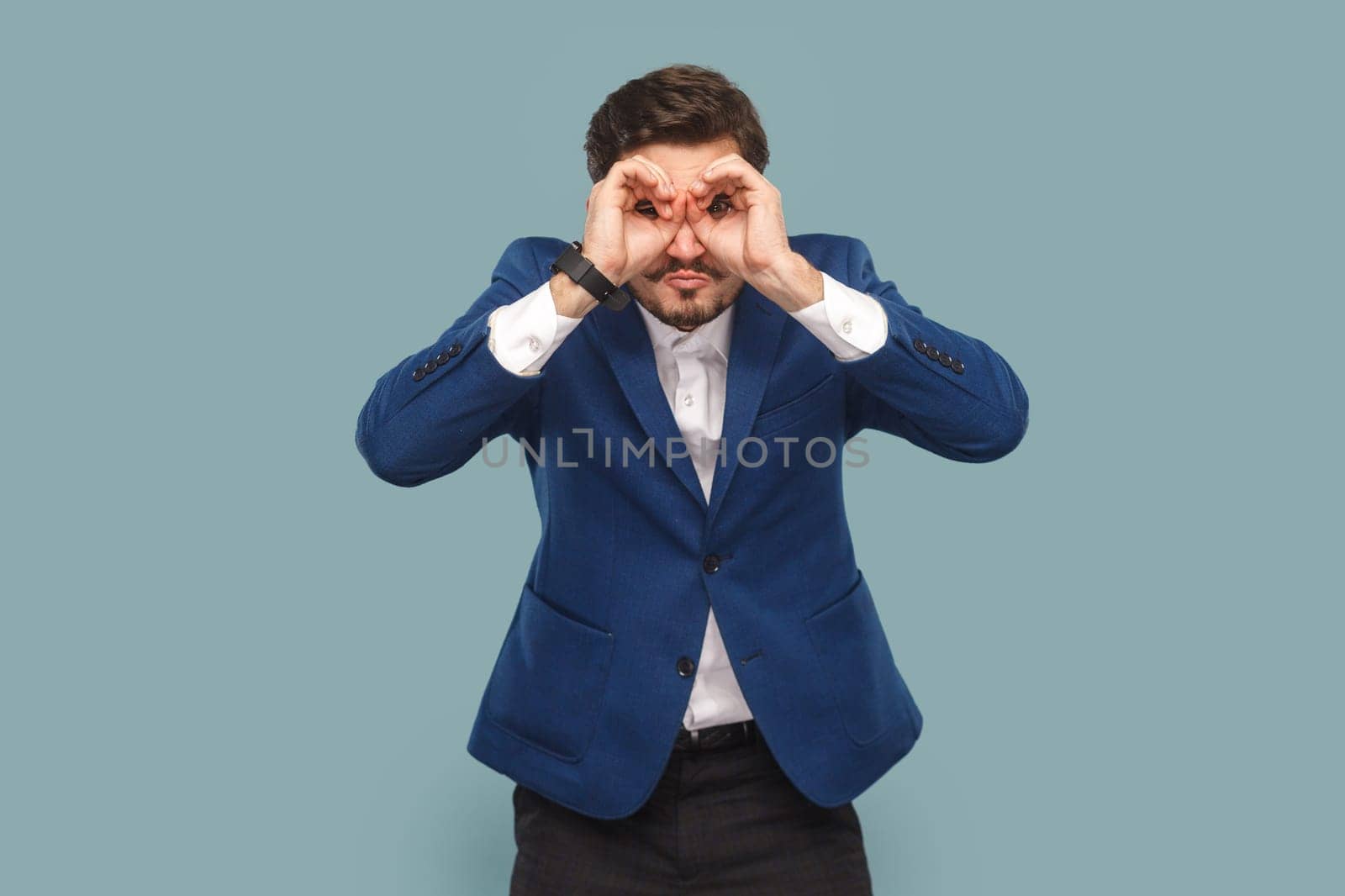 Attractive man standing with binocular gesture, looking far away, expecting good future. by Khosro1