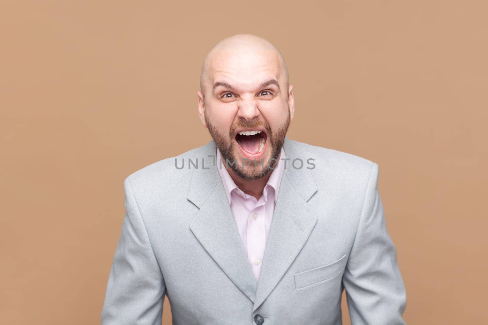 Angry or shocked bald bearded man standing, looking at camera and screaming, arguing with friend. by Khosro1