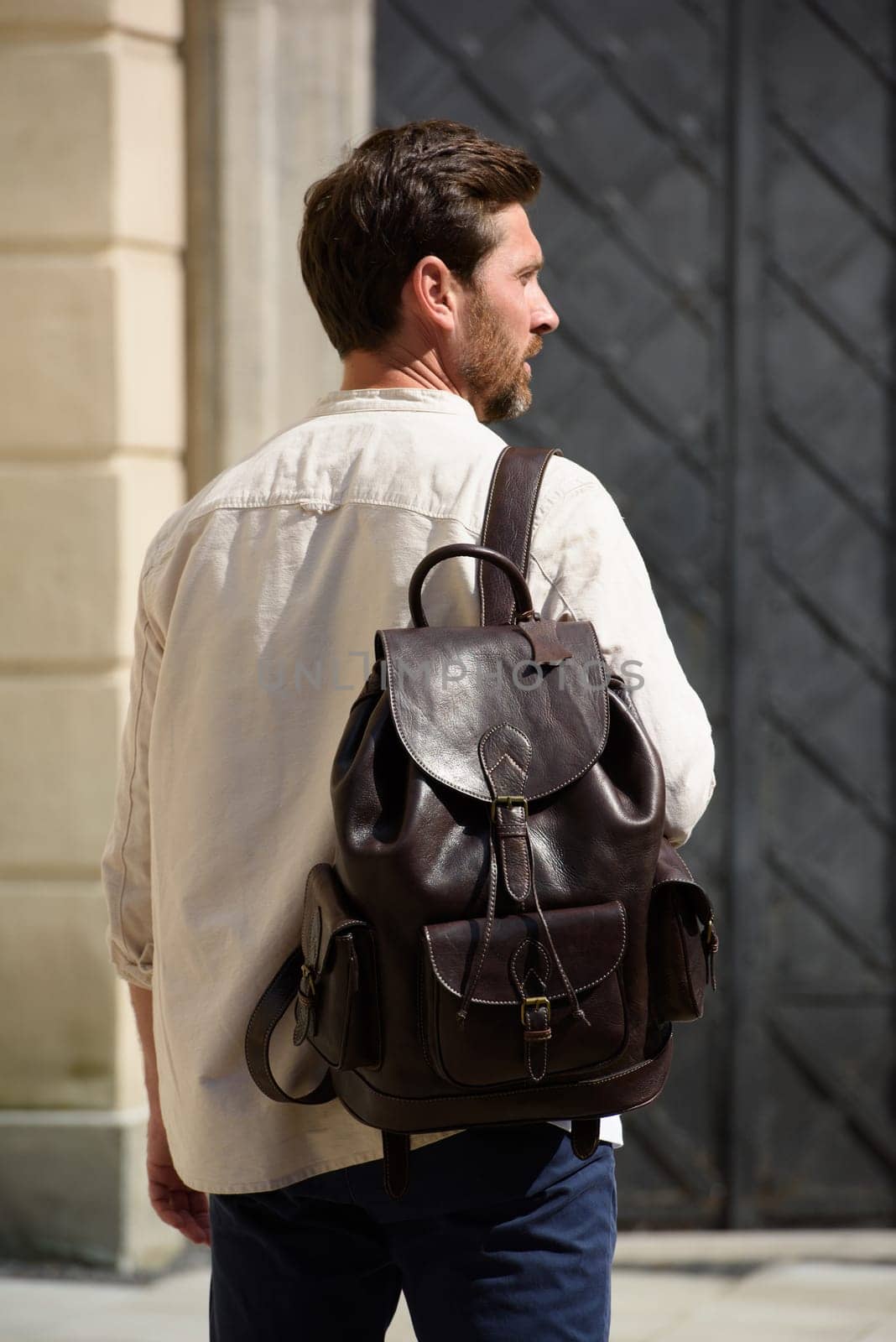 Handsome businessman walking on the street, with luxury leather dark brown backpack. Fashionable style. by Ashtray25