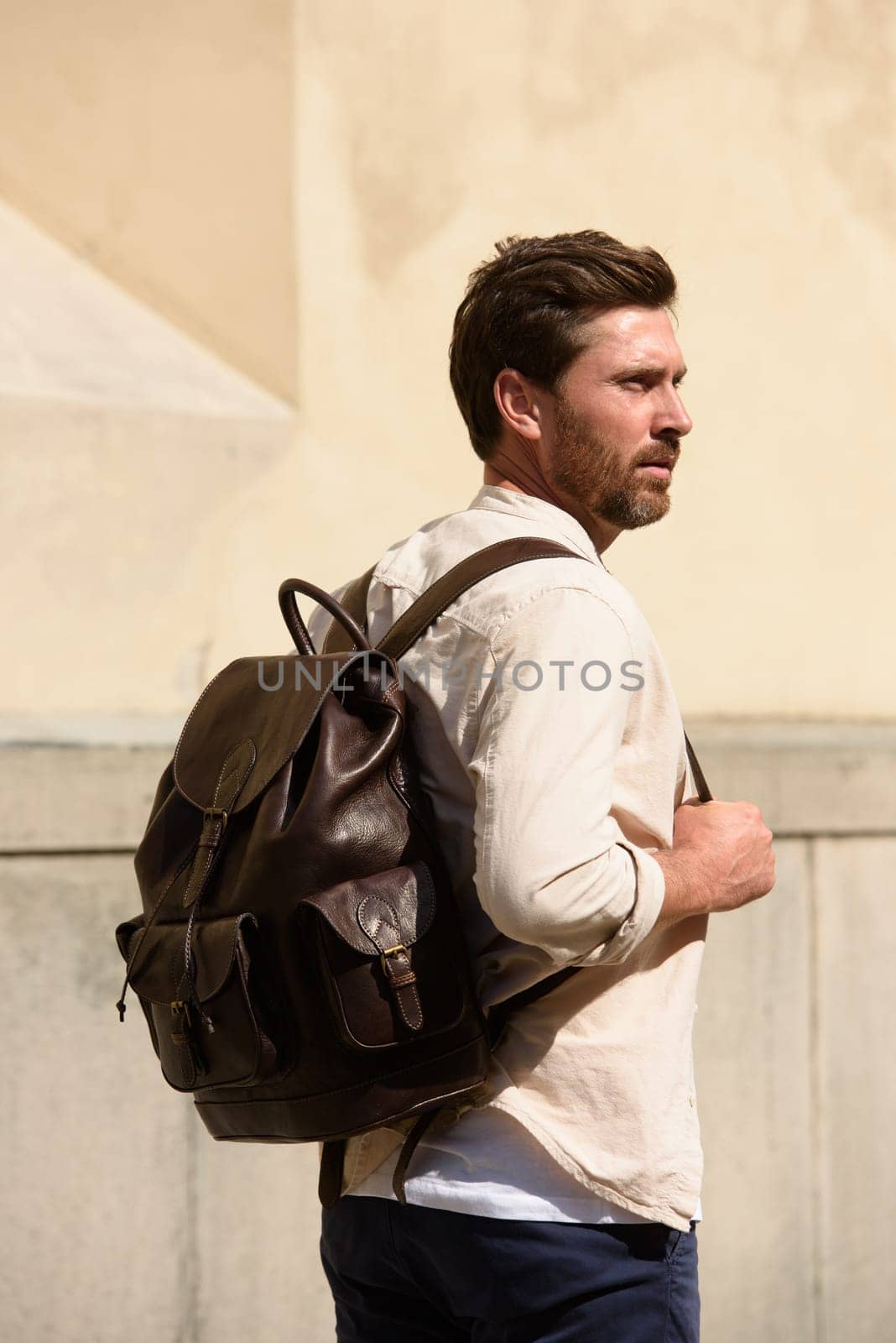 Handsome businessman walking on the street, with luxury leather dark brown backpack. Fashionable style. by Ashtray25