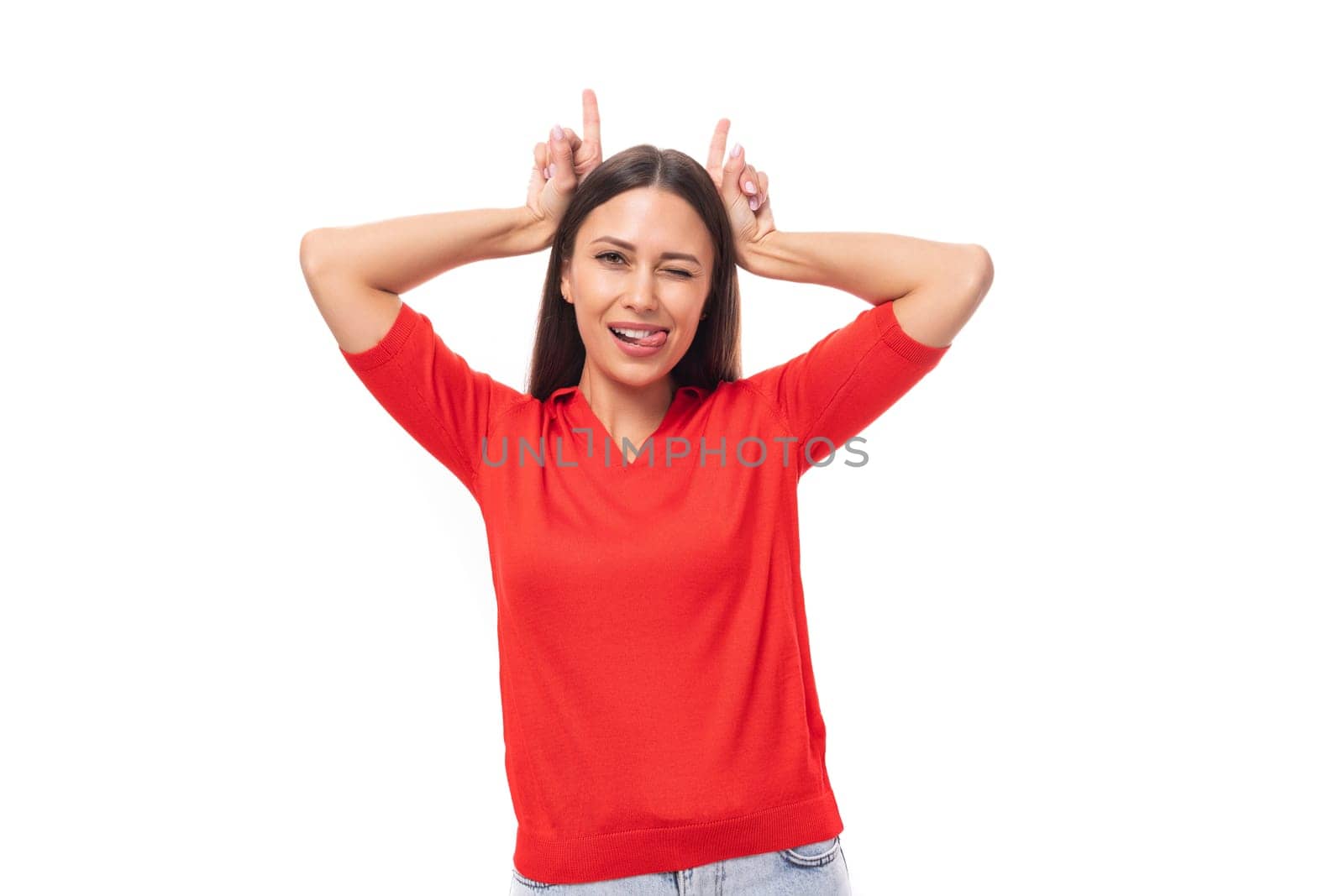 young cute kind european woman with black hair is dressed in a red t-shirt strot grimace with horns.