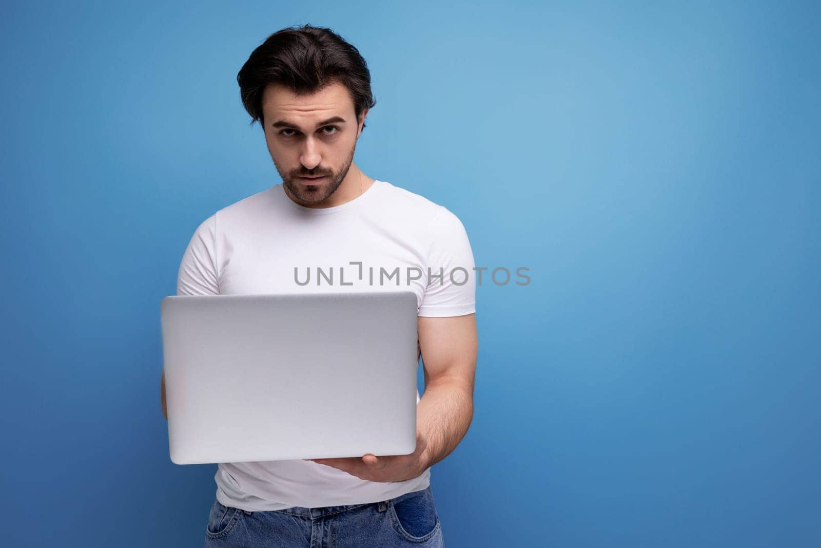 successful freelancer man with laptop in studio.