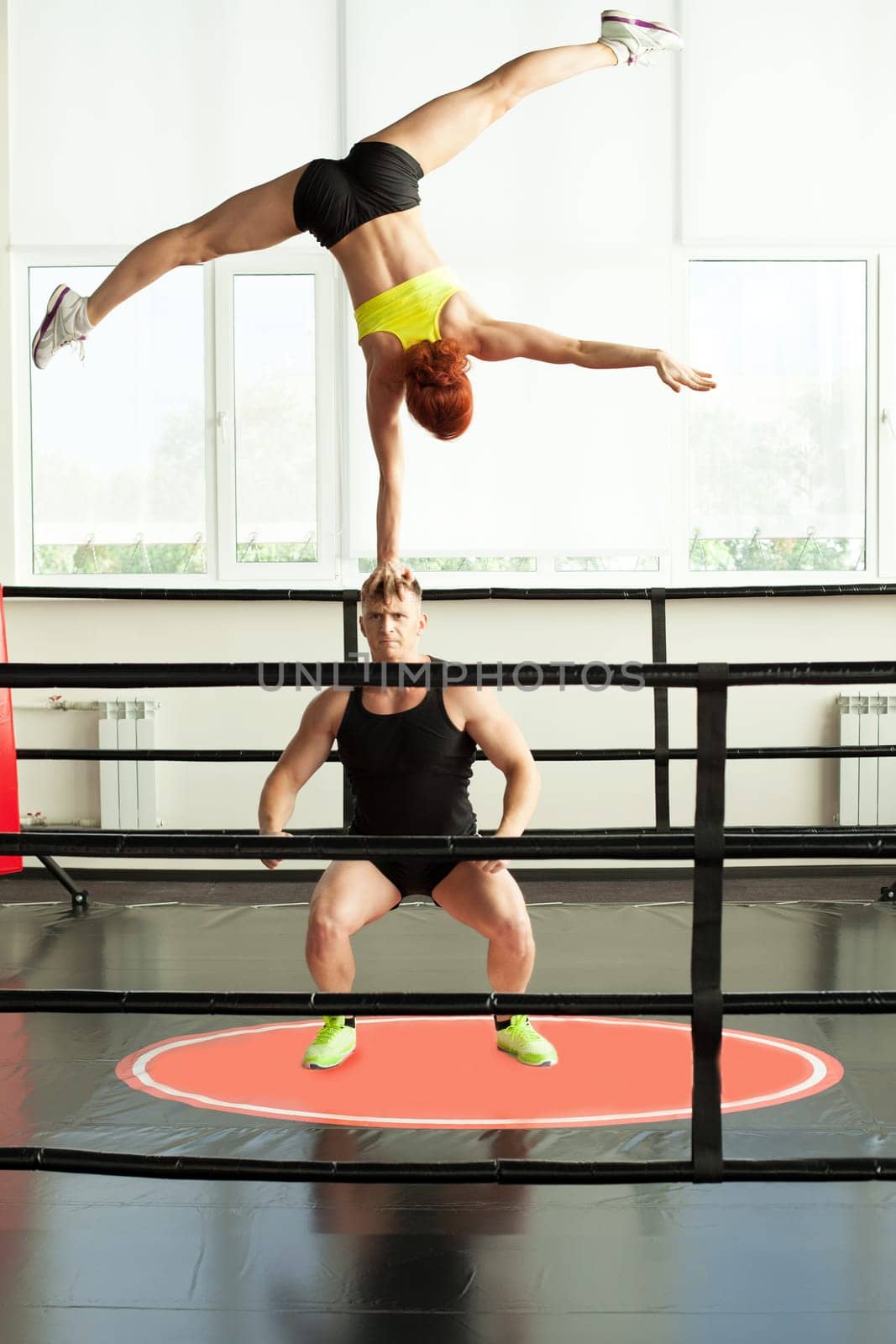 Image of strong man doing acrobatic rack with his partner