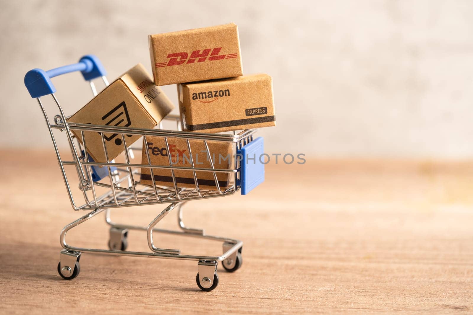 Bangkok, Thailand September 26, 2022 Shopping cart with DHL Amazon and FedEx express packing box, import export online exchange investment business.