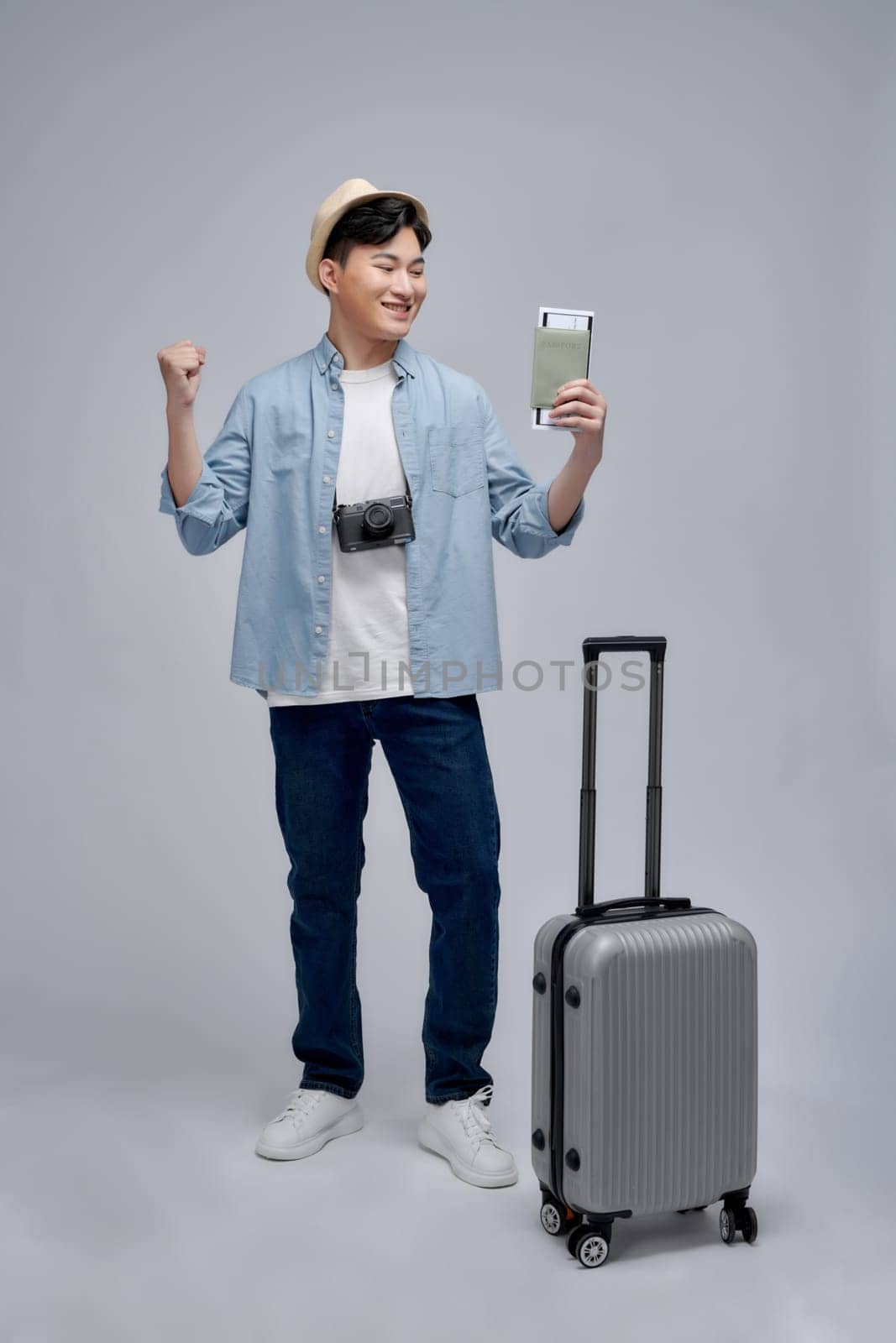 Full body photo of young man happy positive smile tourism holiday suitcase camera passport 