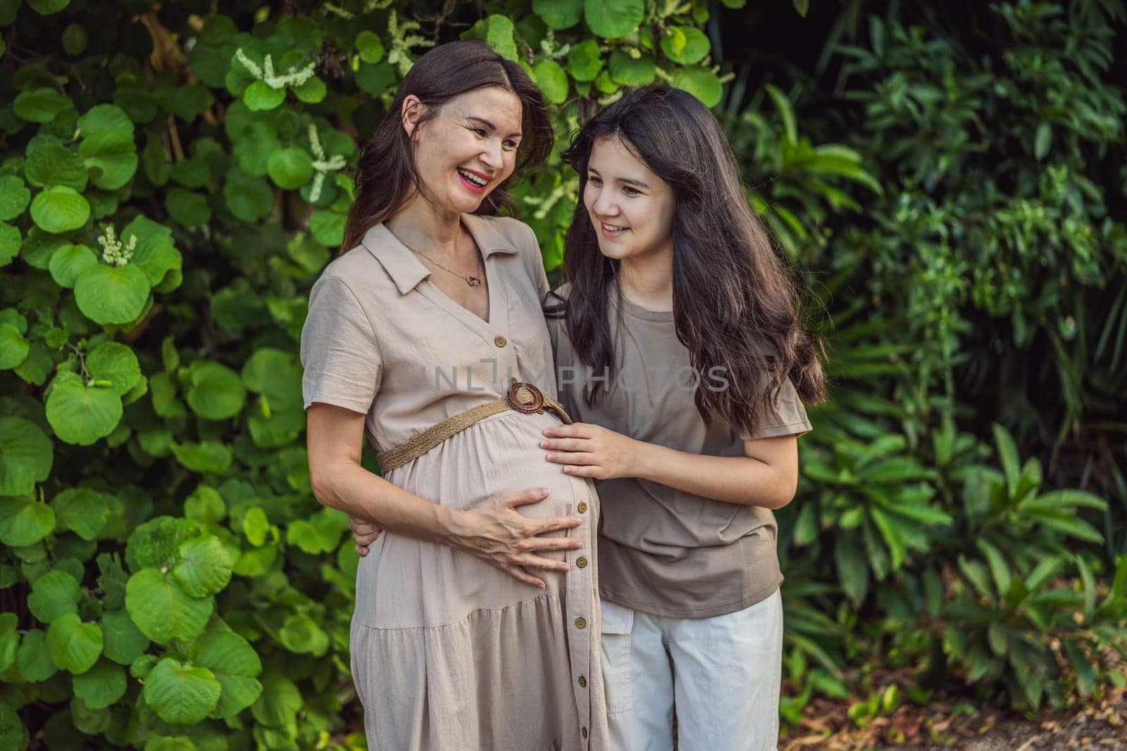 A heartwarming moment captured in the park as a pregnant woman after 40 shares a special bond with her teenage daughter, embracing the beauty of mother-daughter connection.