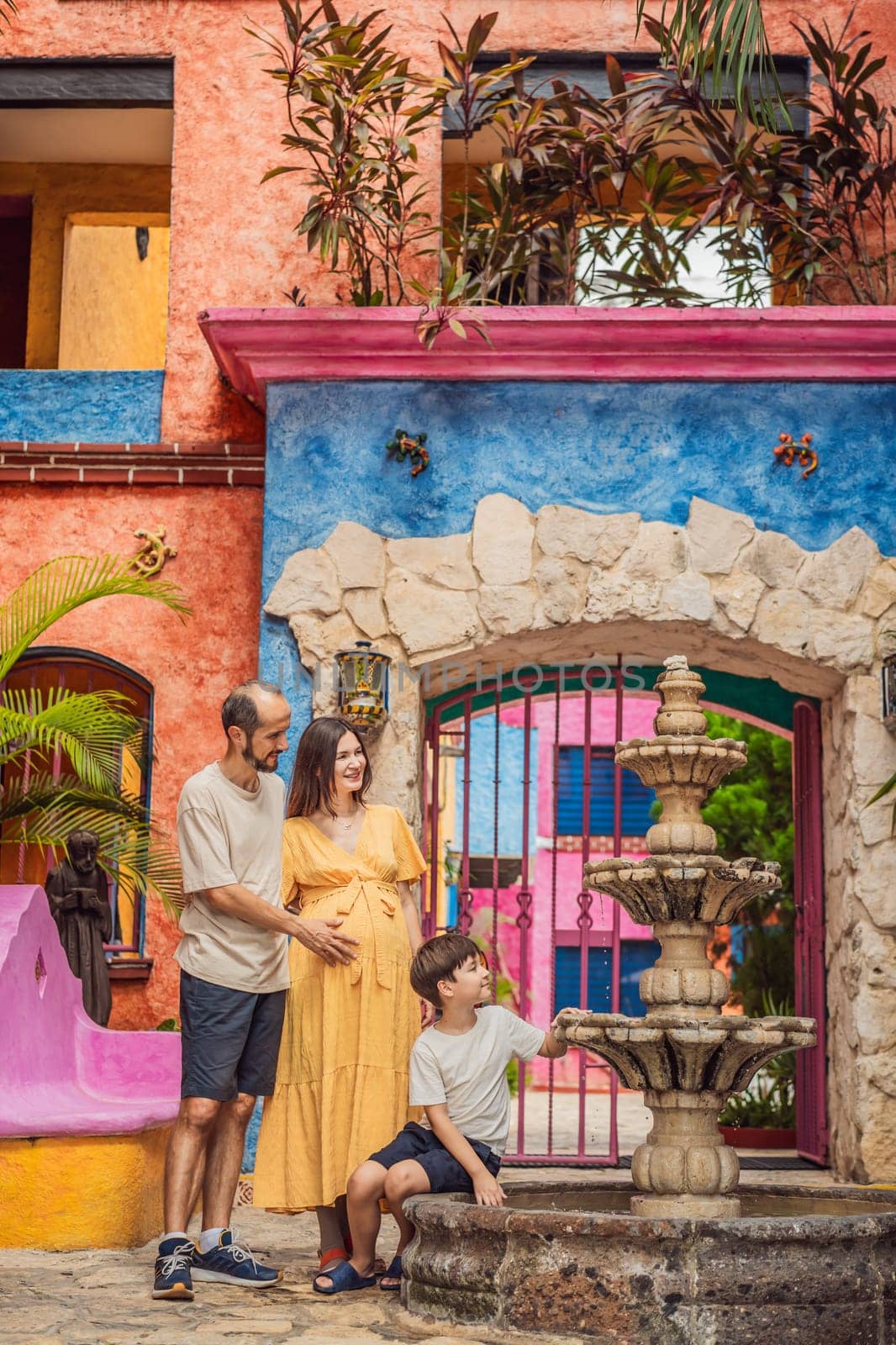 A loving couple in their 40s and their teenage son cherishing the miracle of childbirth in Mexico, embracing the journey of parenthood with joy and anticipation by galitskaya