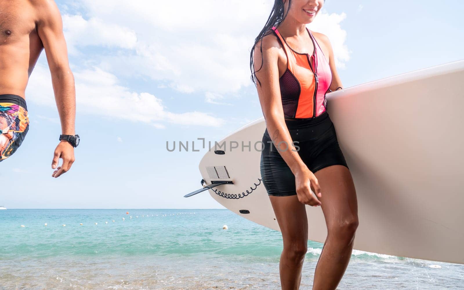 Woman man sea sup. Close up portrait of beautiful young caucasian woman with black hair and freckles looking at camera and smiling. Cute woman portrait in a pink bikini posing on sup board in the sea. by panophotograph