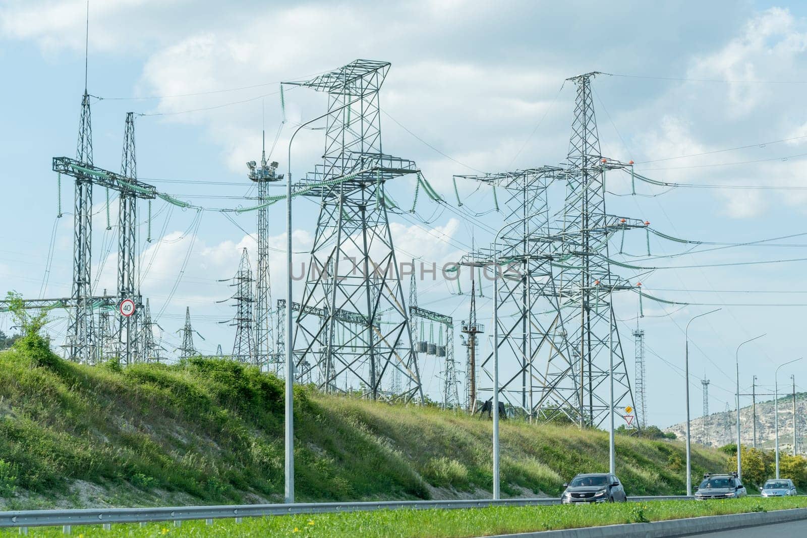 High voltage towers with sky background. Power line support with wires for electricity transmission. High voltage grid tower with wire cable at distribution station. Energy industry, energy saving by Matiunina