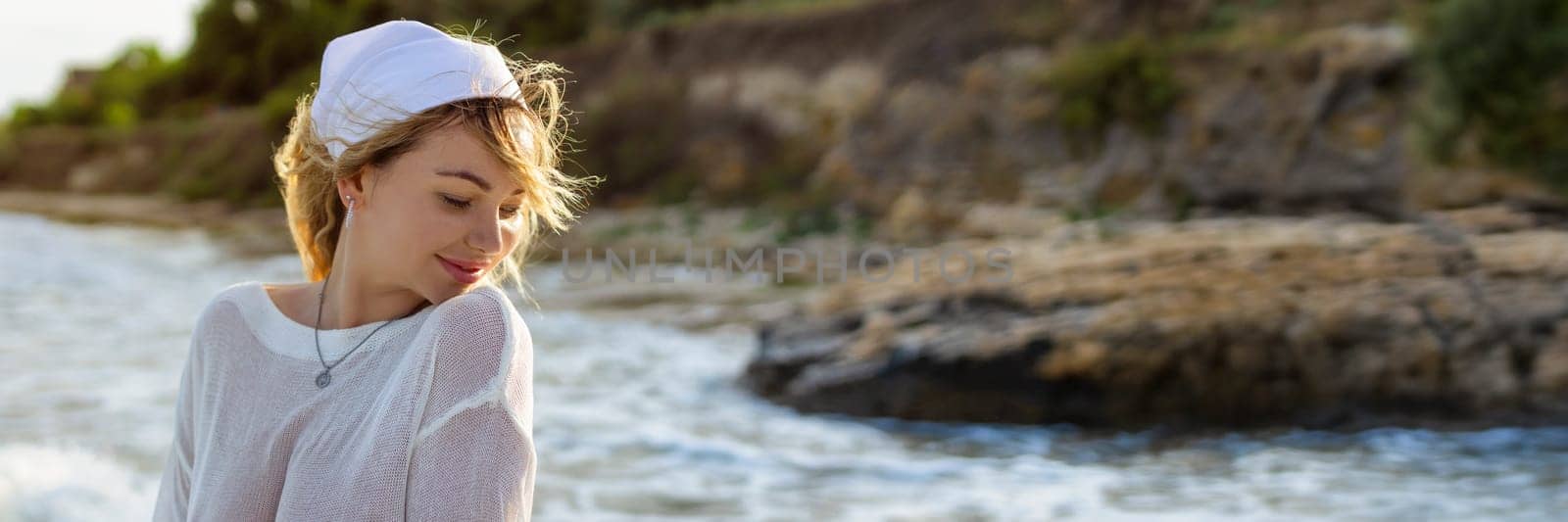 Beach woman in trendy beachwear. caucasian tourist girl in white pareo for sun protection, relaxing walk in ocean water during summer holidays. by malyshph