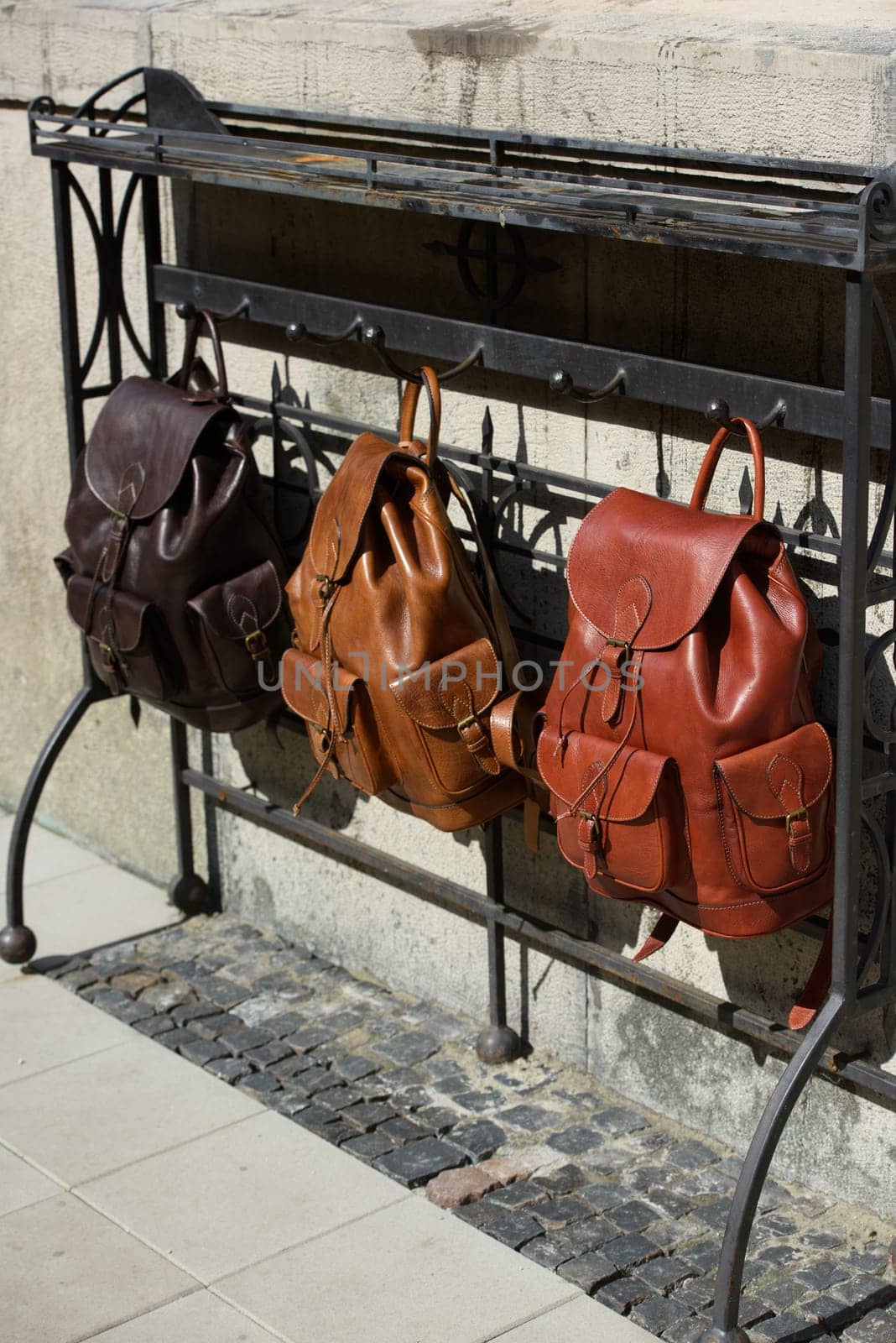 Collection of different stylish backpacks. Street photo.