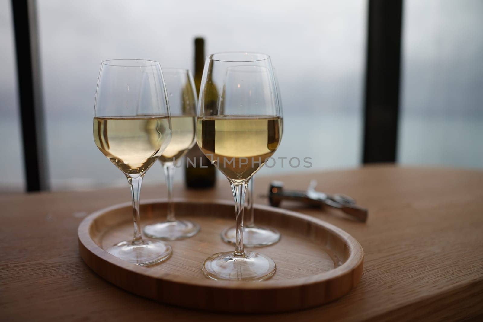 Glasses on tray with elite white wine by kuprevich