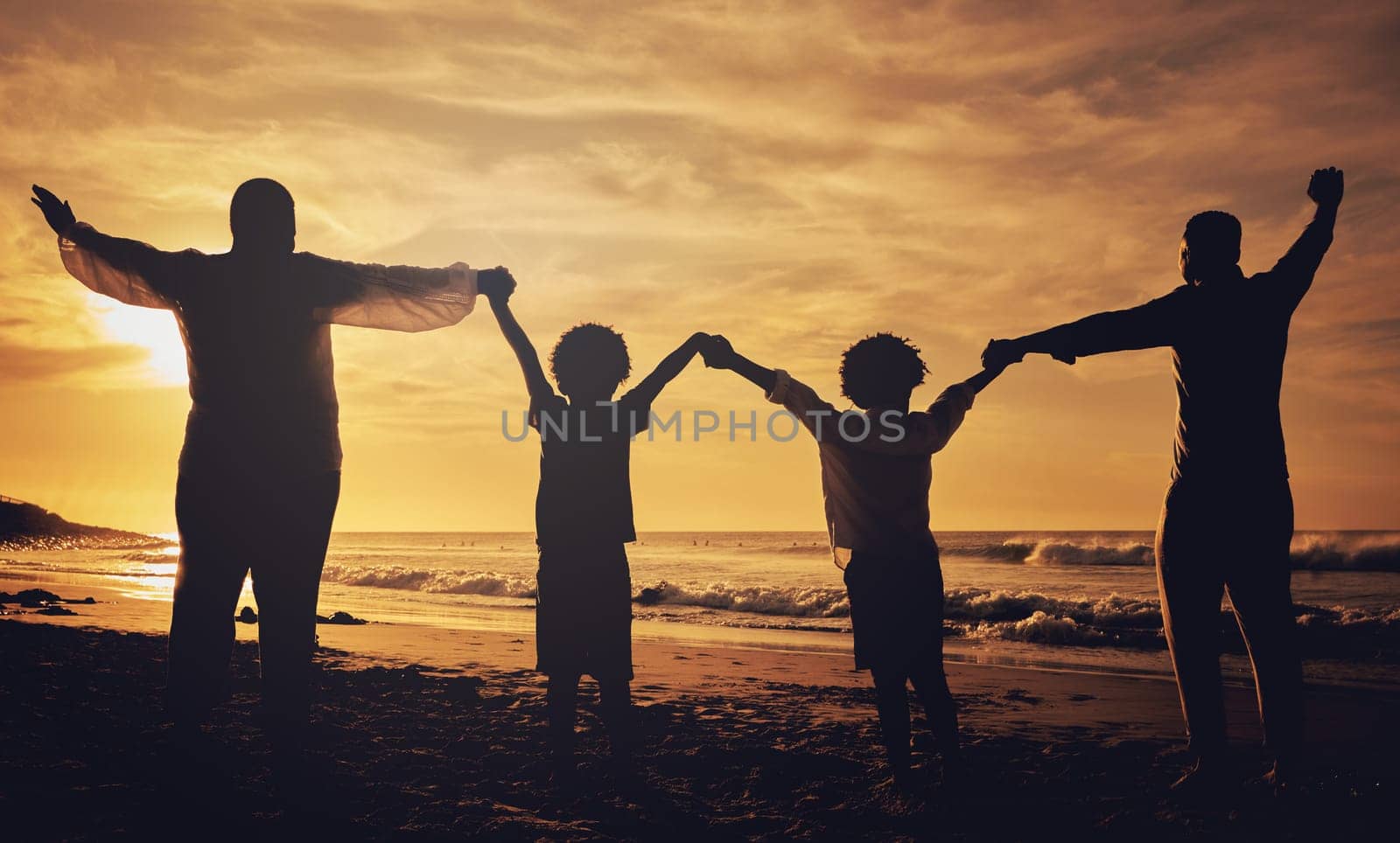 Holding hands, sunset and silhouette of a family at the beach with love, freedom and happiness. Summer, travel and back of parents with children, affection and together in the dark by the ocean.