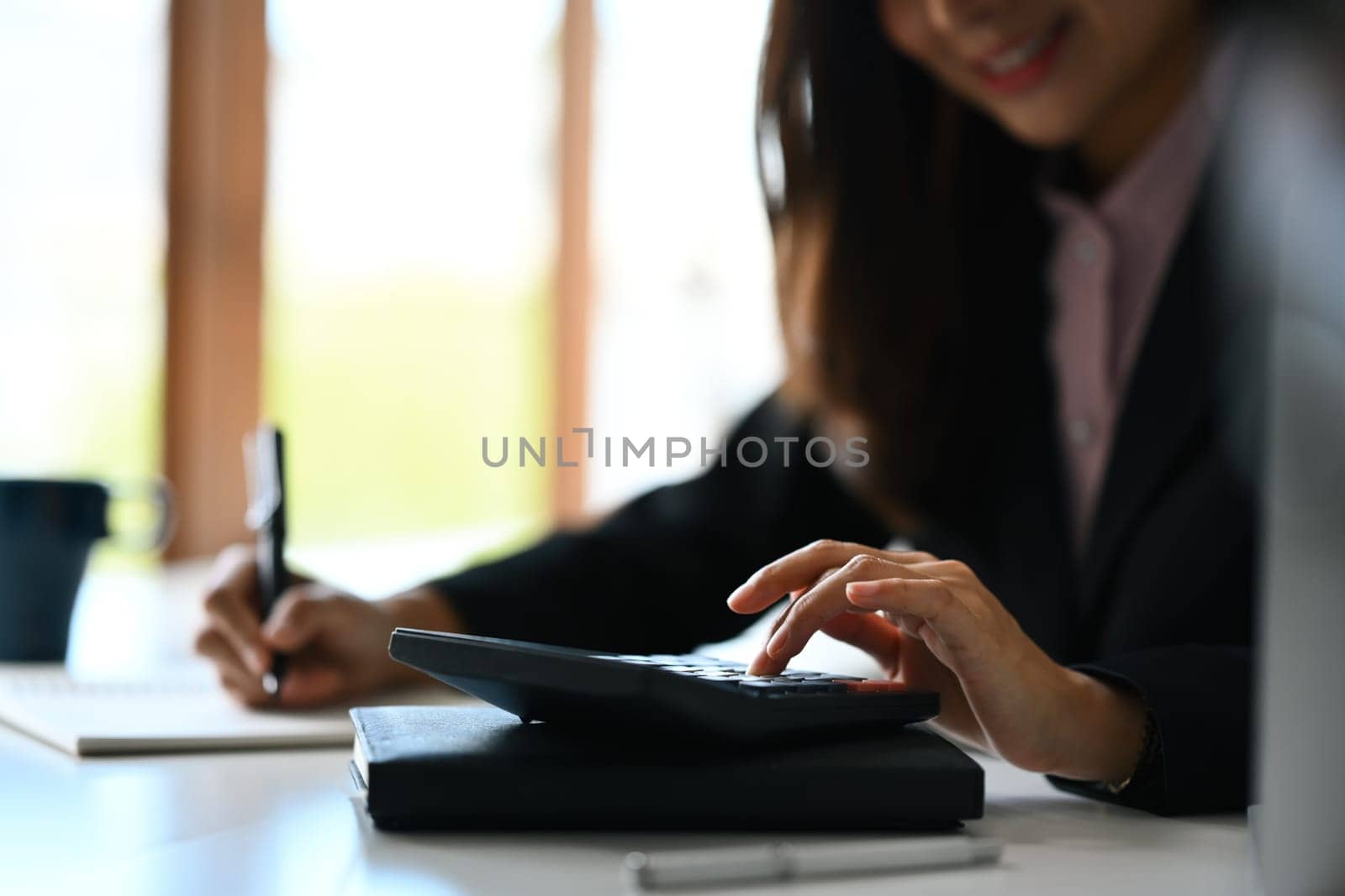 Beautiful asian woman entrepreneur working on investment and marketing projects at modern office.