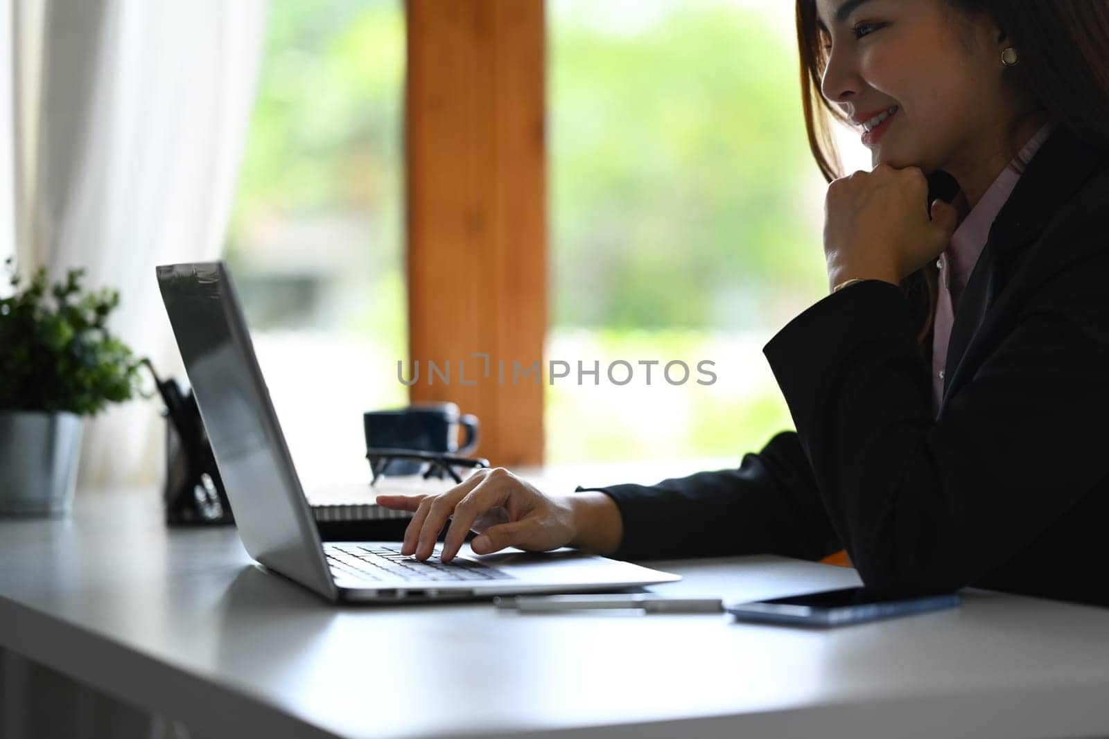 Beautiful asian woman entrepreneur working on investment and marketing projects at modern office.