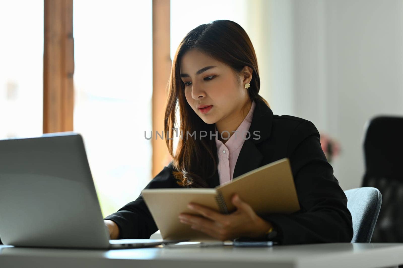 Beautiful asian woman entrepreneur working on investment and marketing projects at modern office.