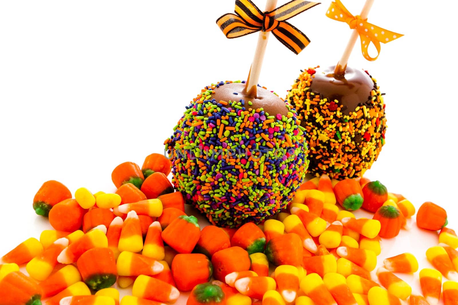 Hand dipped caramel apple covered with multi color sprinkles.