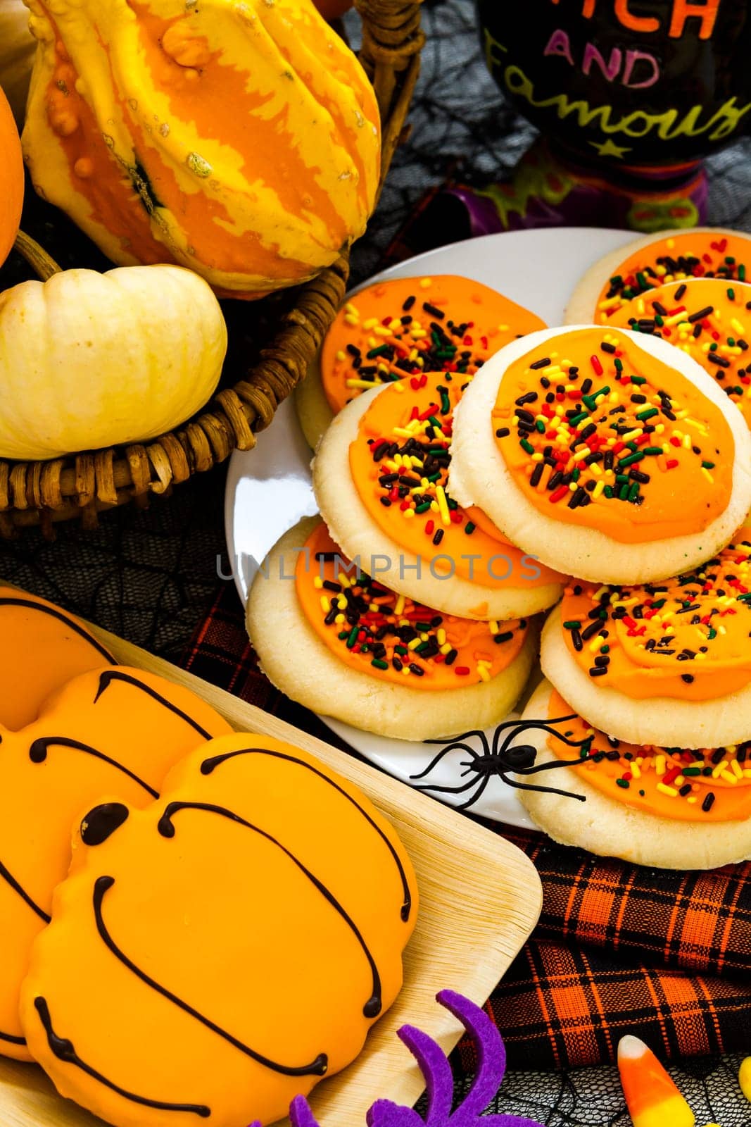 Sugar cookies with orange icing and spkinkles.