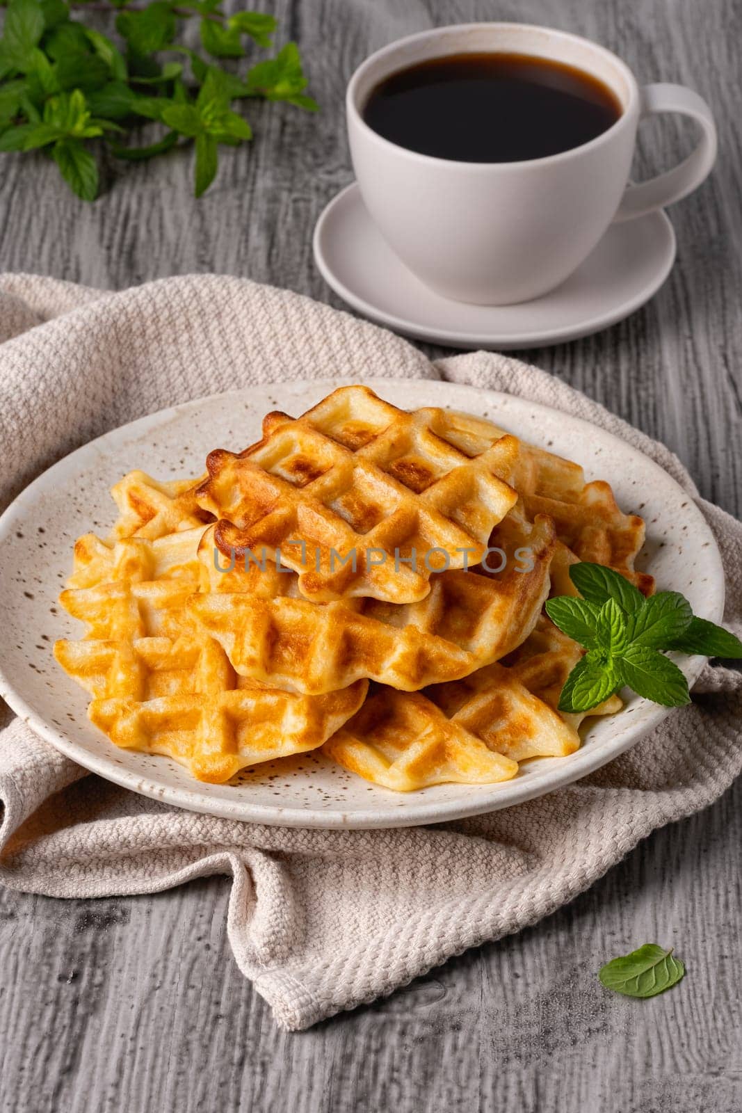 Belgian waffles and coffee on a gray background..