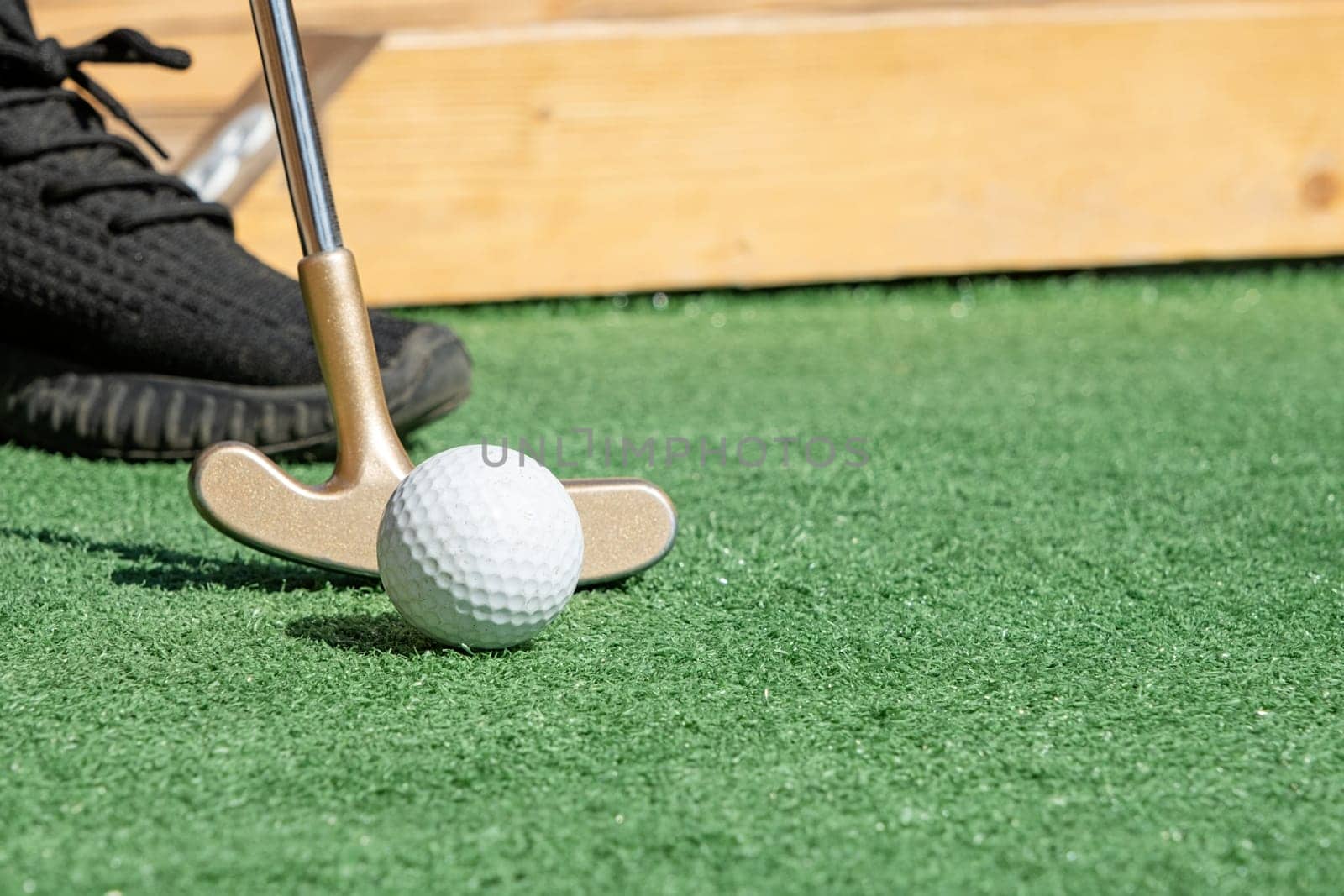 Summer hobbies. unrecognizable person playing mini golf