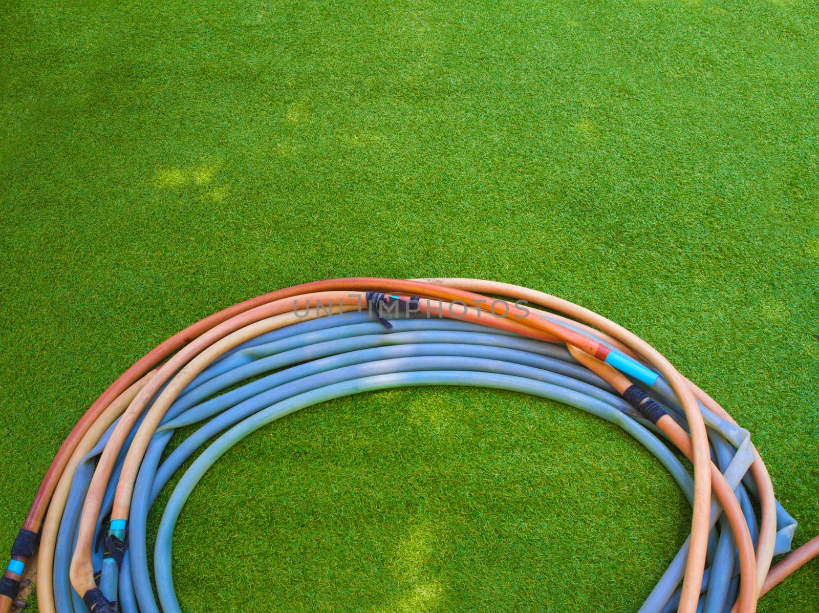 The old Rubber hose on Artificial grass by Satakorn