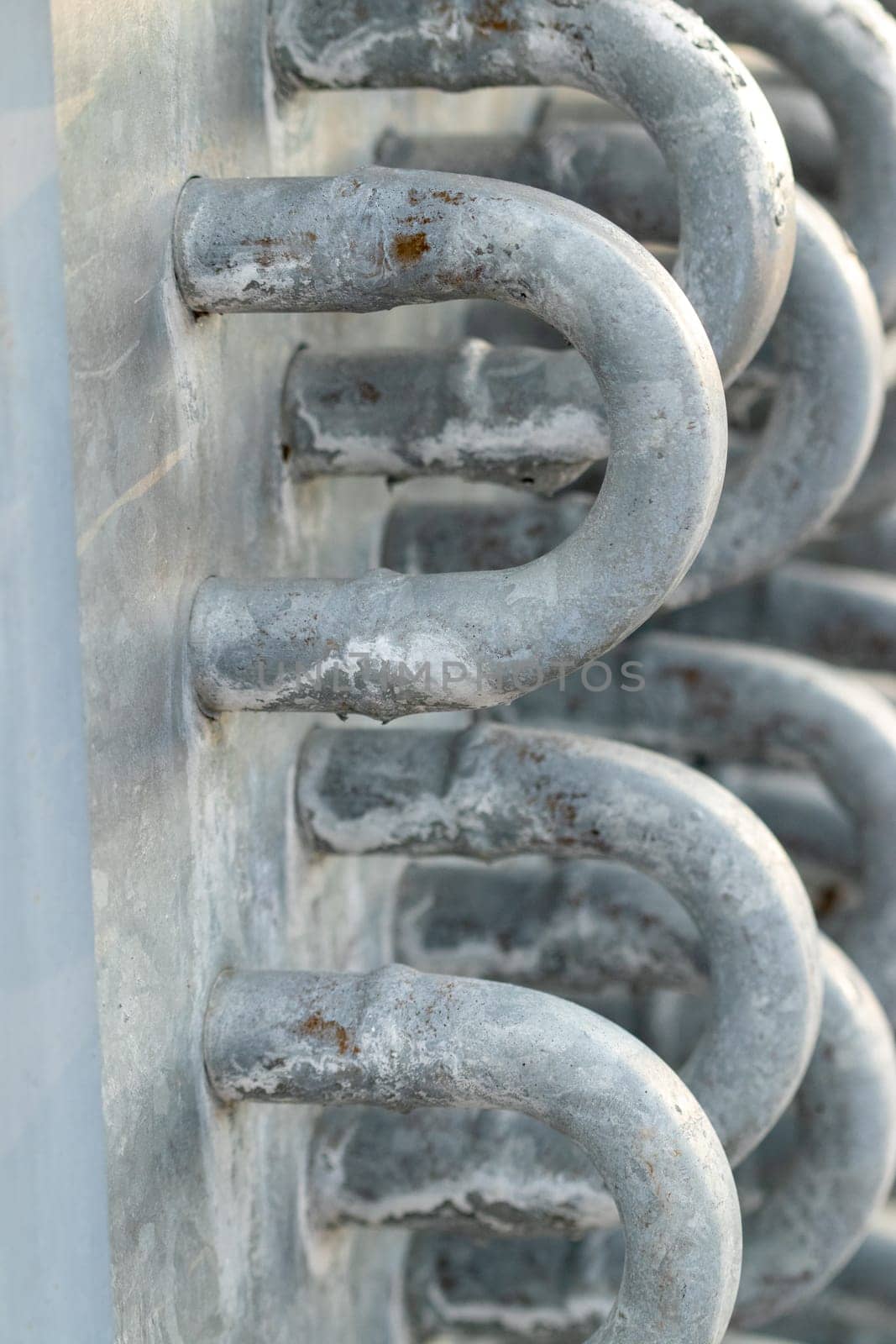 water end flow coil tubes from a large air conditioner close up background . High quality photo