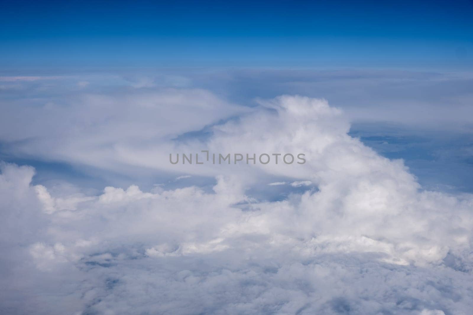 Big white clouds in a blue sky close-up. There is a place for the text by AnatoliiFoto