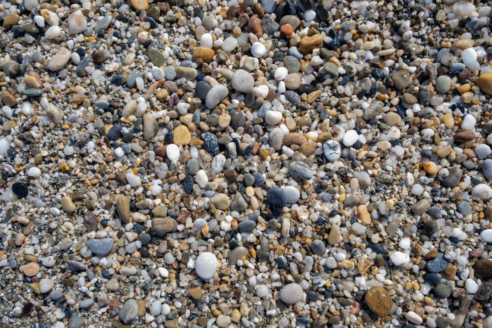 Crushed stone on the seashore. Selective focus on object. The stones were laid on the ground in the garden as a background. Background blur. Pebble stones background.