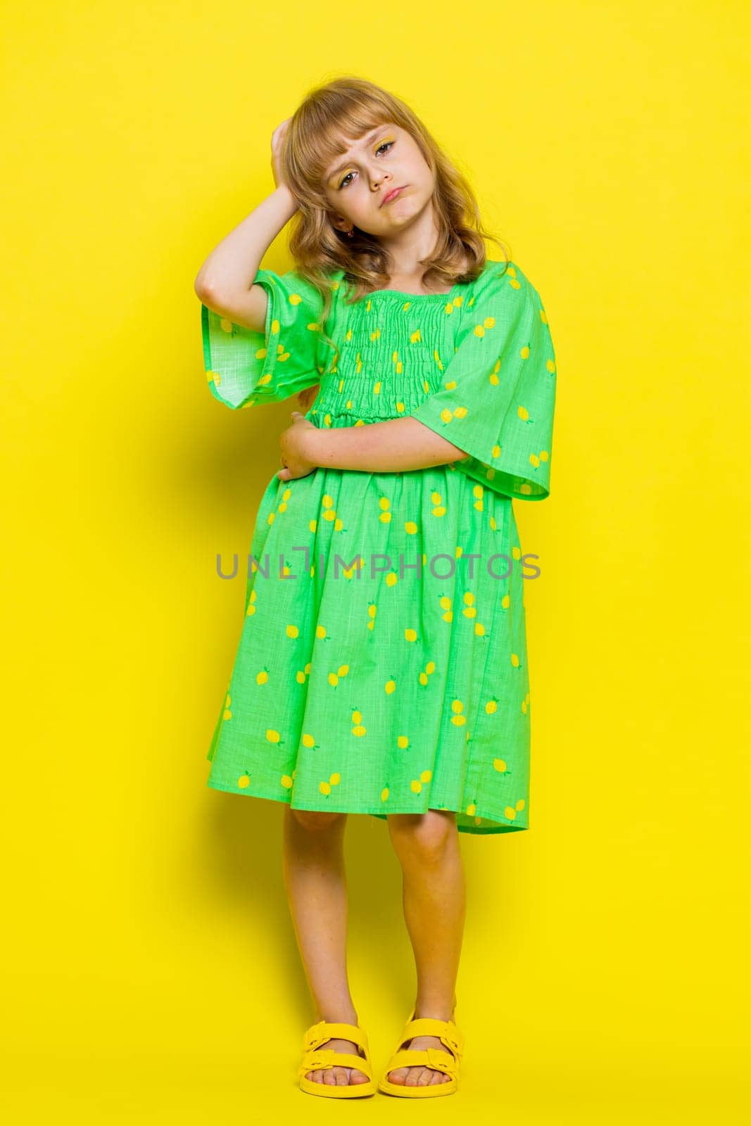 Young school girl feeling hopelessness loneliness, nervous breakdown, loses play game surprised by lottery results, bad fortune, loss, unlucky news. Preteen child kid on yellow background. Vertical