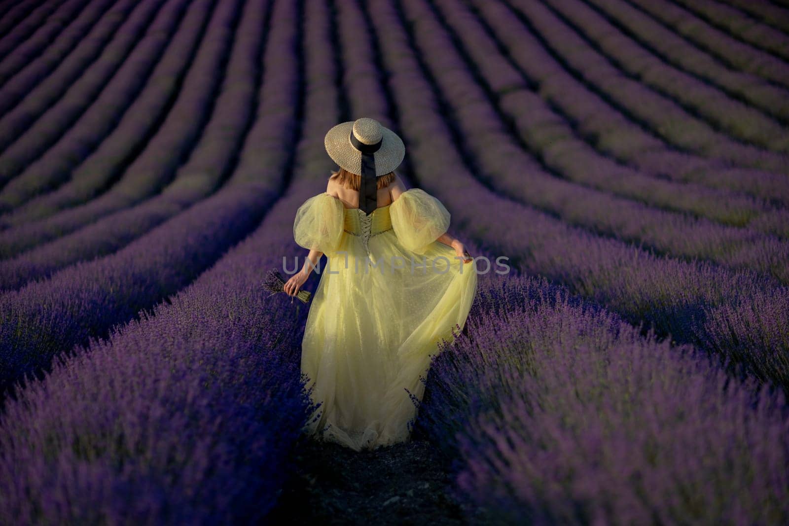 Lavender field happy woman in yellow dress in lavender field summer time at sunset by Matiunina