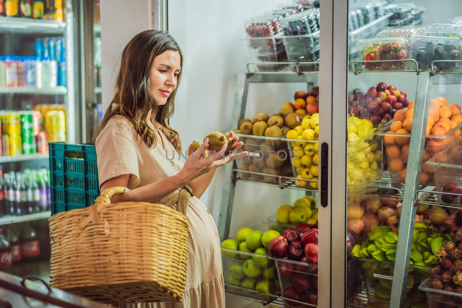 A glowing pregnant woman after forty makes a healthy choice as she selects organic vegetables and fruits at the vibrant organic market, prioritizing her well-being and her baby's health.