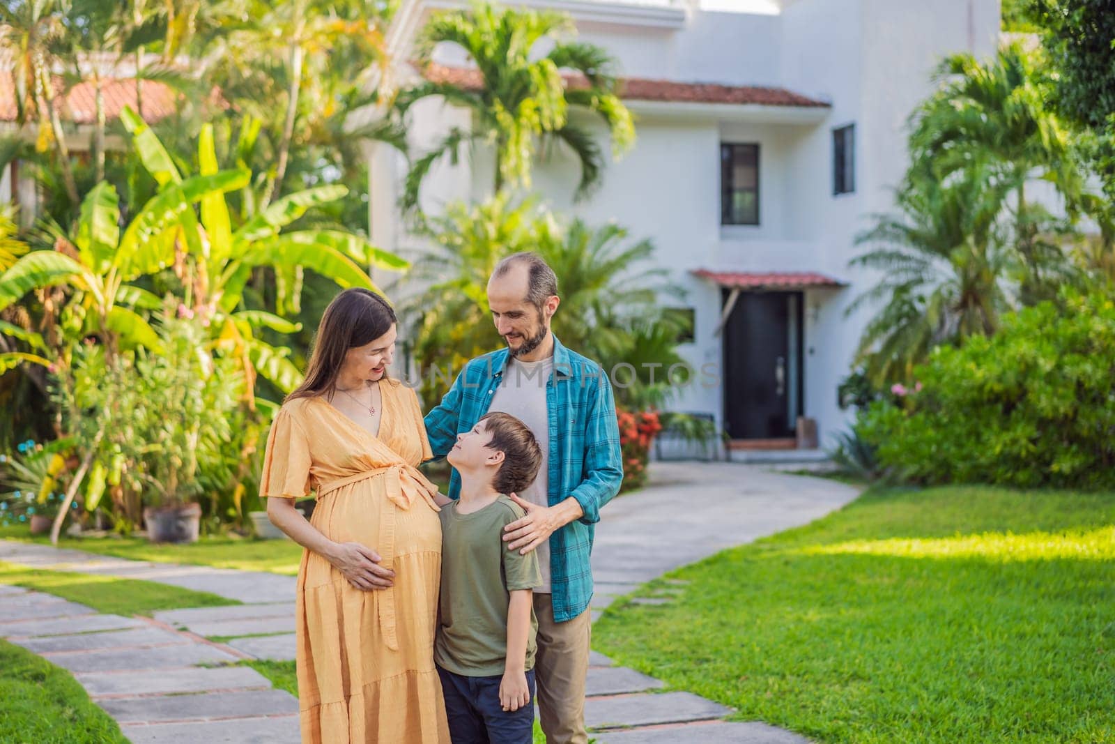 A heartwarming photo depicting a family after 40, with a pregnant mom, dad, and their teenage son, celebrating their new milestone of buying a house together by galitskaya