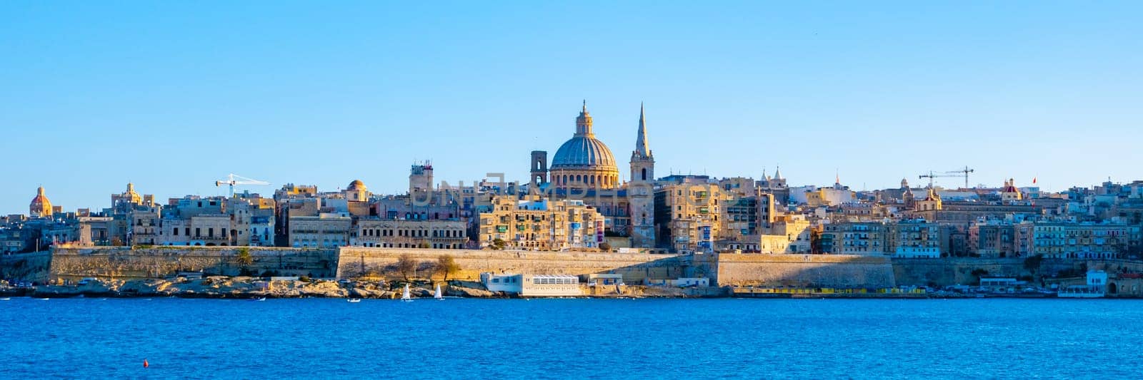 Valletta Malta city Skyline, colorful house balcony Malta Valletta, panoramic view over Valletta Malta old town at sunset