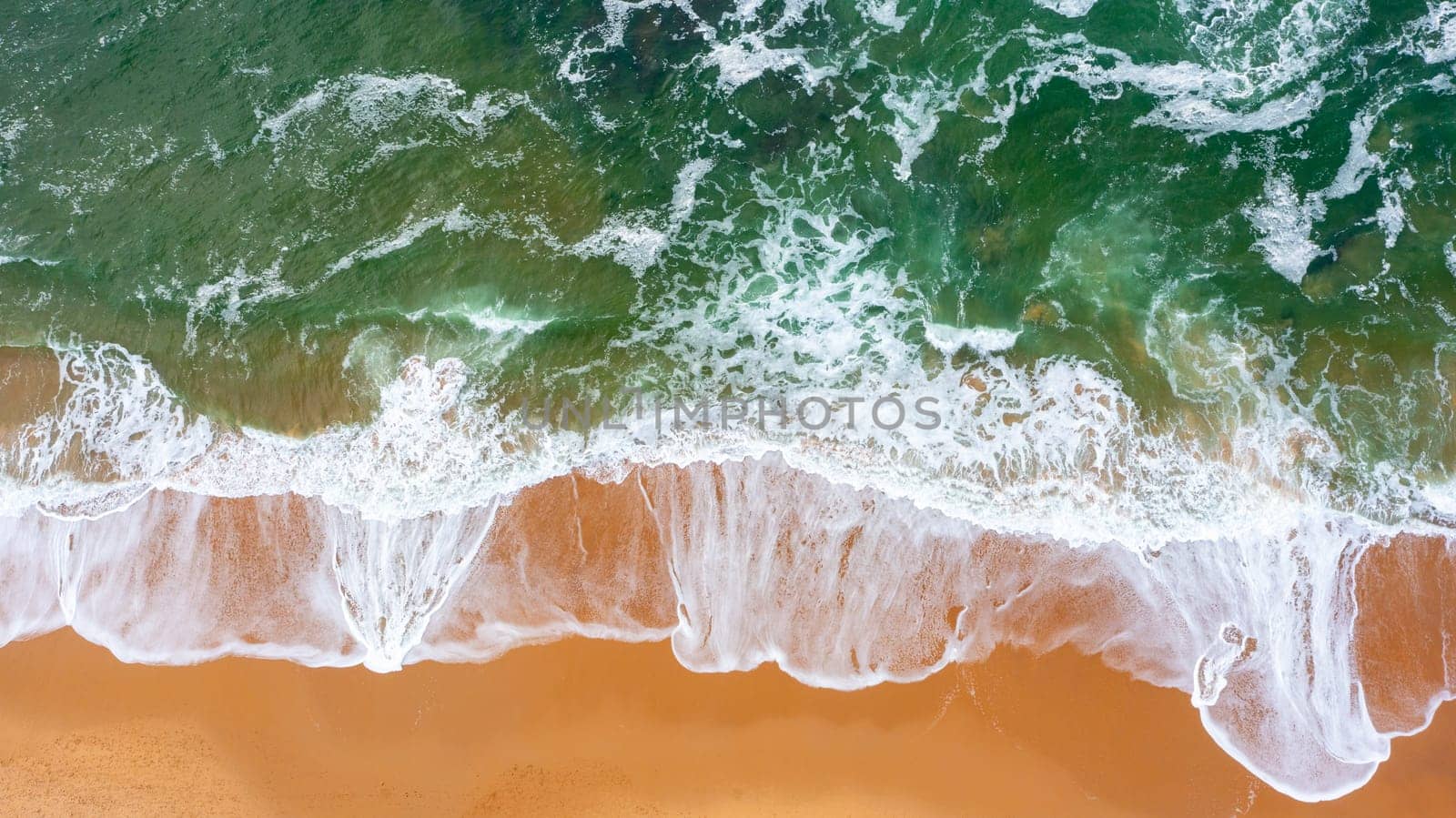 Aerial view of beautiful tropical beach and sea with sand and wave. Turquoise color water