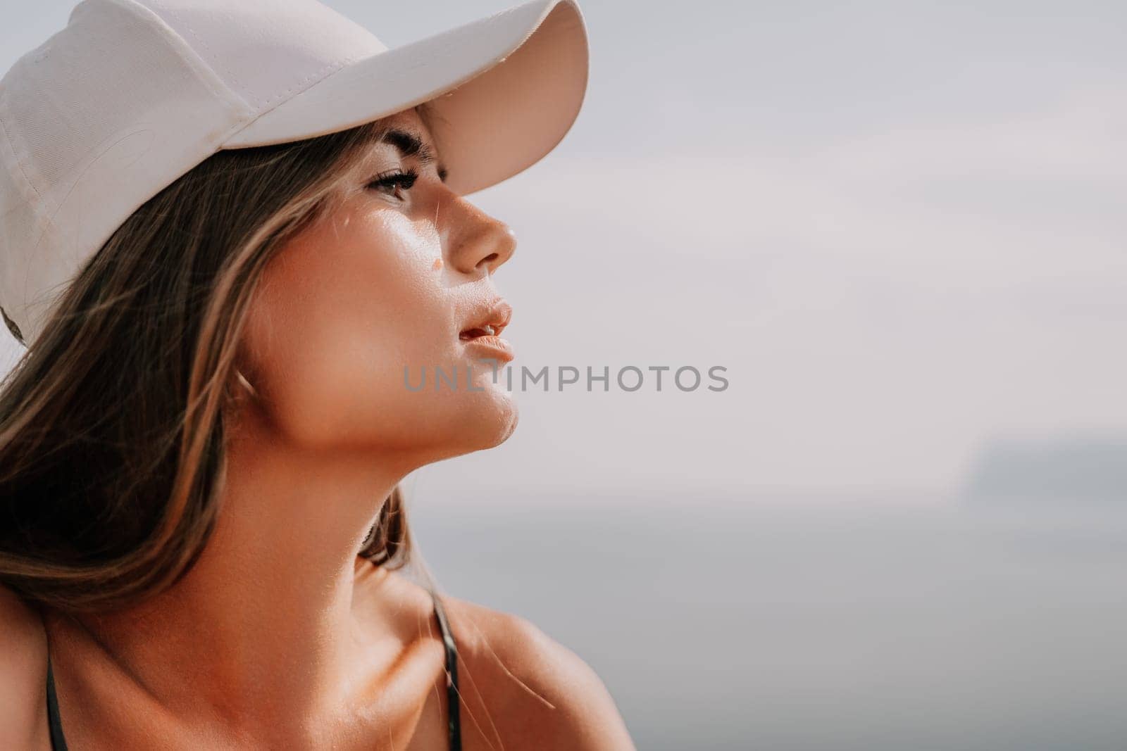 Woman travel sea. Happy tourist taking picture outdoors for memories. Woman traveler looks at the edge of the cliff on the sea bay of mountains, sharing travel adventure journey by panophotograph