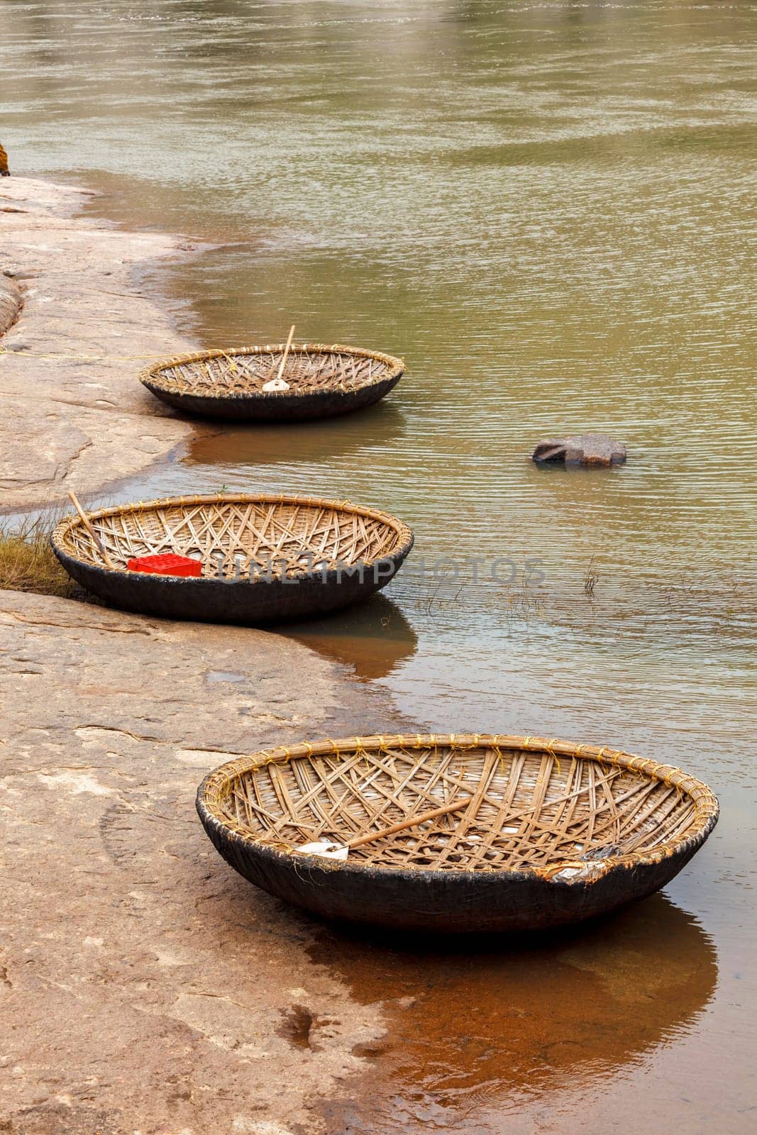 Traditional wickerwork coracle boat in Hampi on bank of Tungabhadra river, Hampi, Karnataka, India