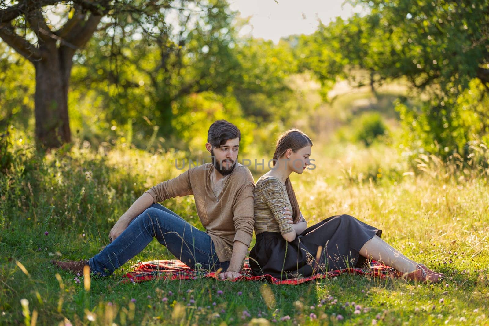 couple sitting in nature by zokov