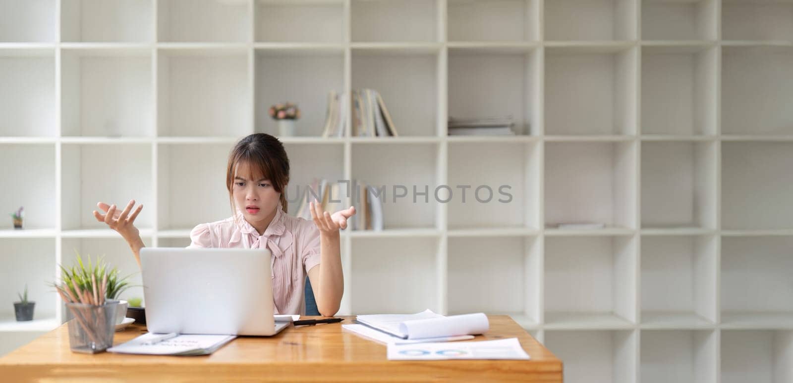 Asian business woman got stressed at work during in the office room, stressed face while working.