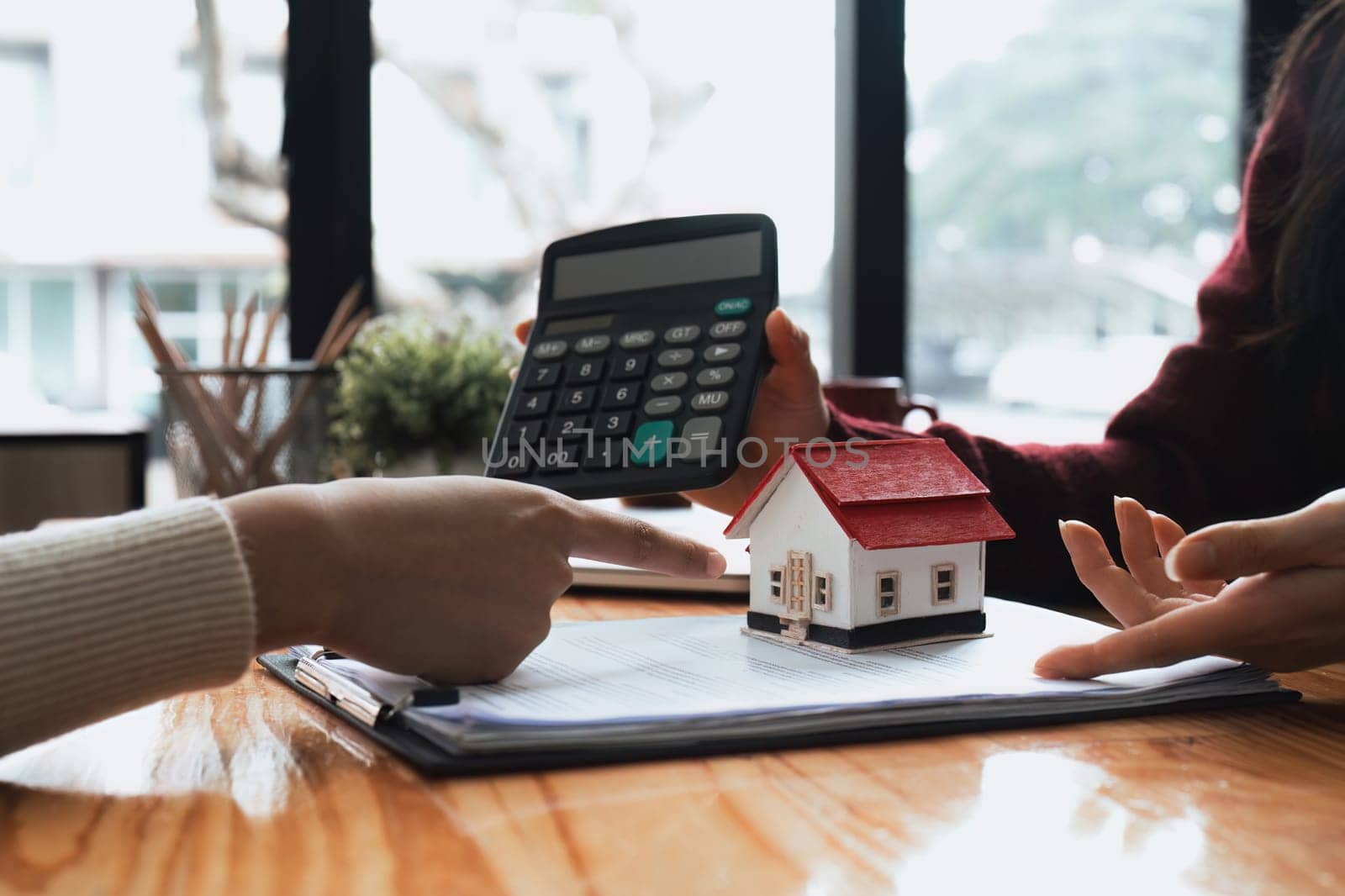 Real estate agent to his discussion and consult about house contracts client after signing contract, concept for real estate, moving home or renting property by nateemee