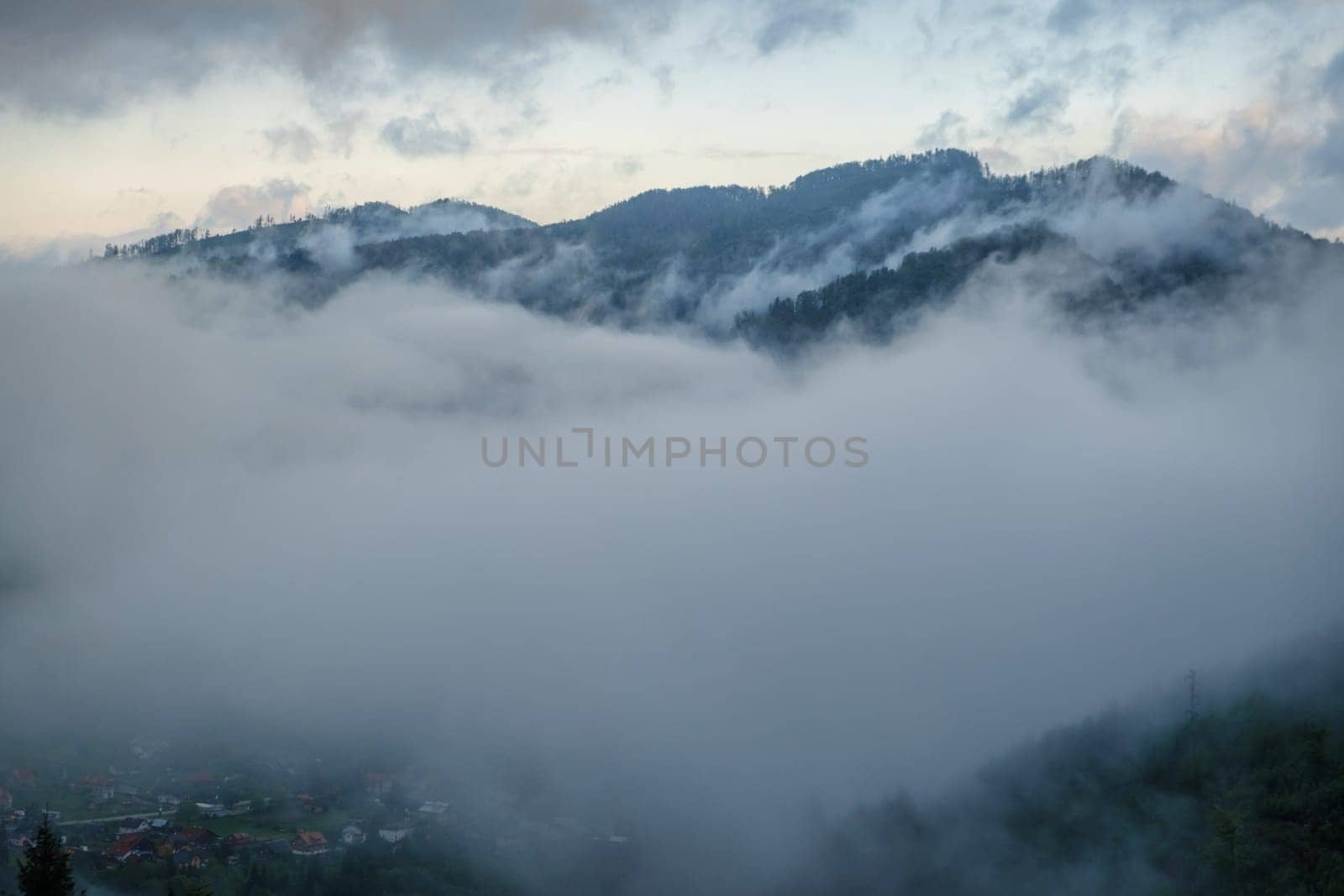Fog over the mountains. Aerial view of fog over mountains in morning. download photo