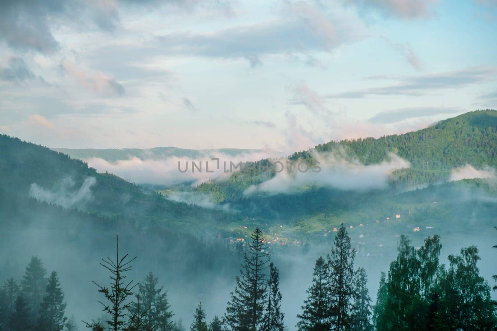 Wonderful countryside with fog under sunlight. Fog over the mountains. Unsurpassed misty morning in the mountains during sunrise. Amazing nature scenery. Stunning alpine Landscape. download photo