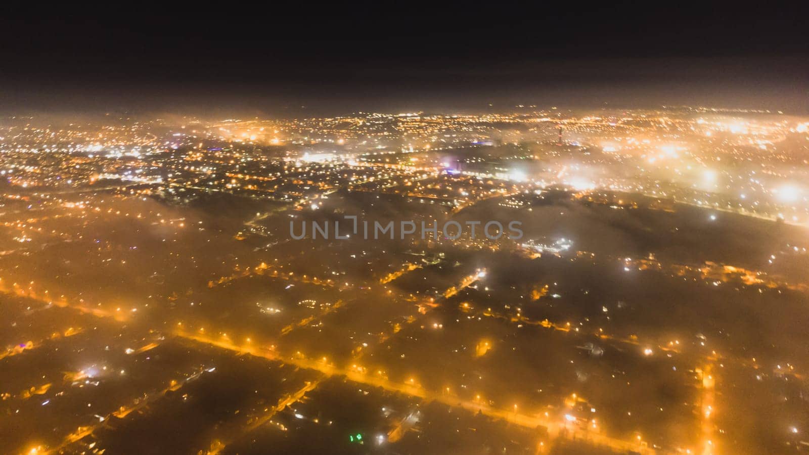 light bokeh city landscape at night sky with many stars, blurred city by fog covered by igor010